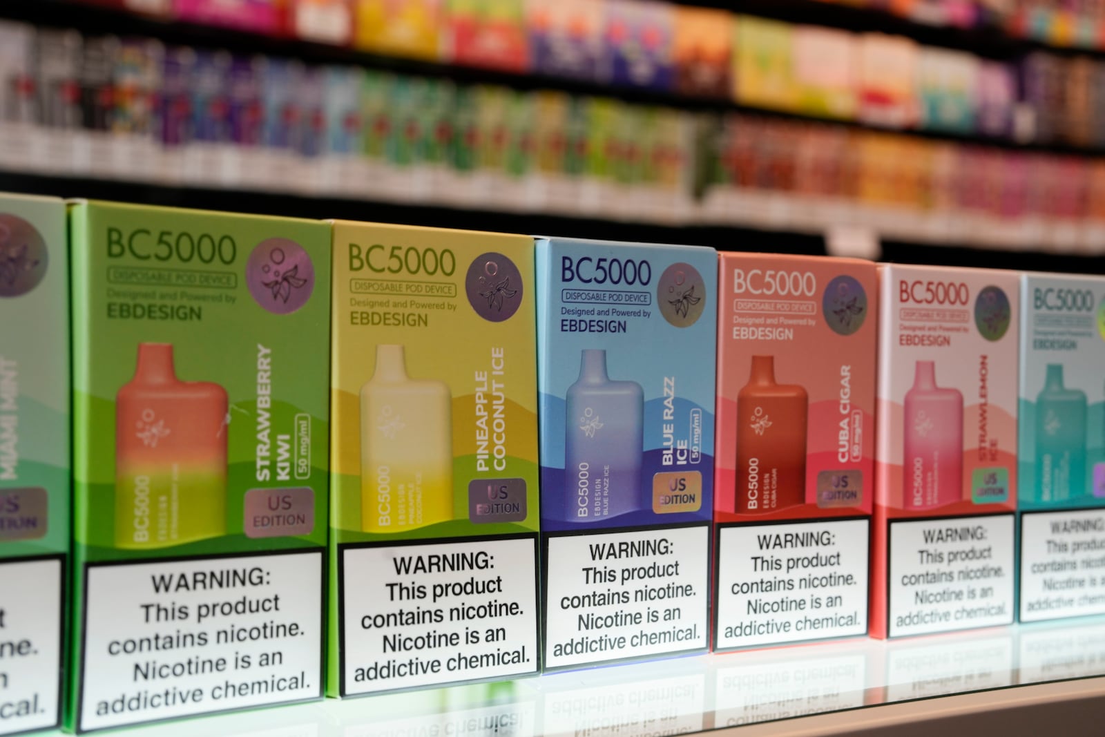 A few of the varieties of disposable flavored electronic cigarette devices manufactured by EB Design, formerly known as Elf Bar, are displayed at Vapes N Smoke in Pinecrest, Fla., Monday, June 26, 2023. Since 2020, the number of different e-cigarette devices for sale in the U.S. has exploded to more than 9,000, a nearly three-fold increase driven almost entirely by a wave of disposable vapes from China. (AP Photo/Rebecca Blackwell)