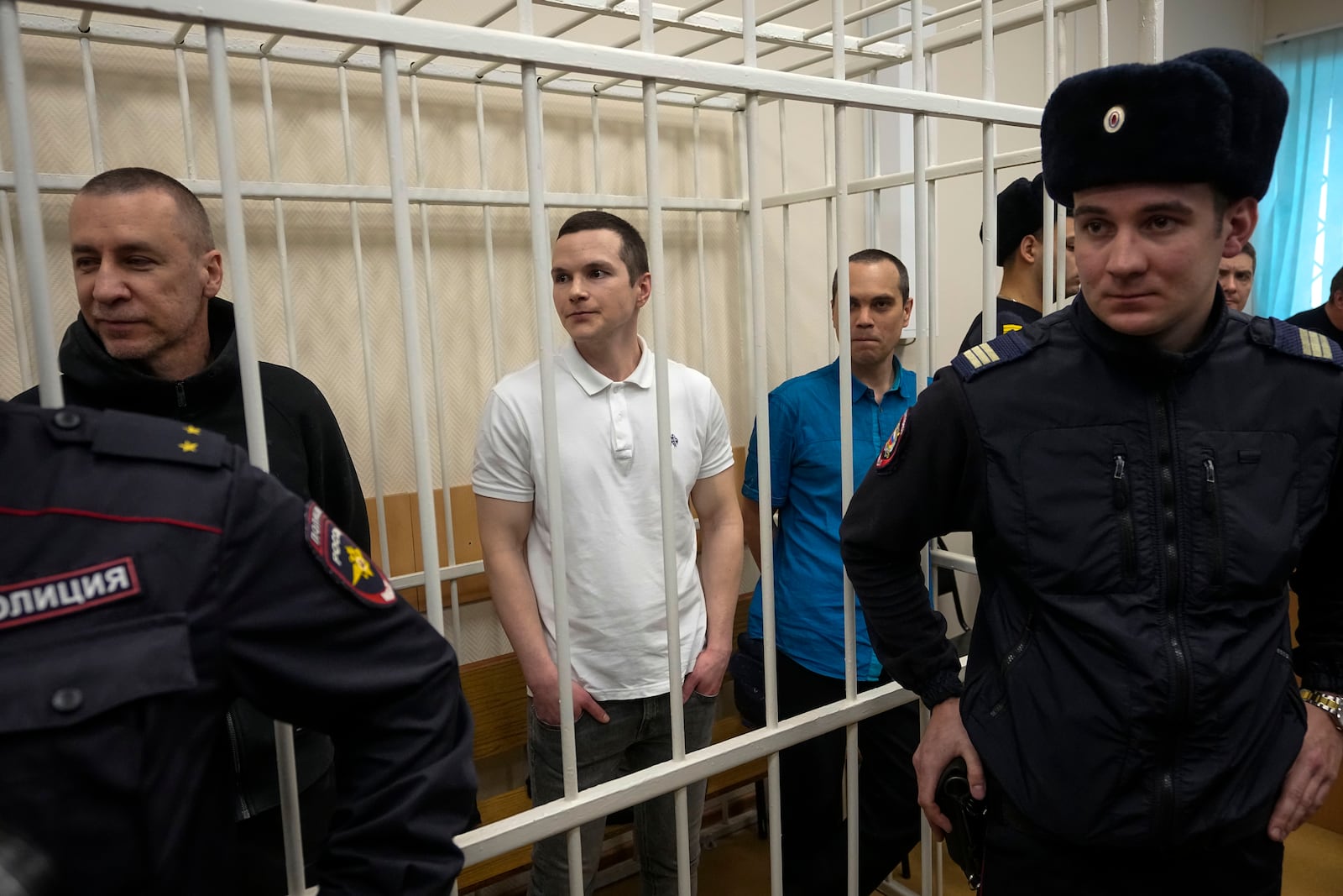 Lawyers Igor Sergunin, from left, Alexei Liptser and Vadim Kobzev, all who once represented late opposition leader Alexei Navalny, stand in a courtroom in Petushki, Vladimir region, about 120 kilometers (75 miles) east of Moscow, Russia, Friday, Jan. 17, 2025. (AP Photo/Pavel Bednyakov)