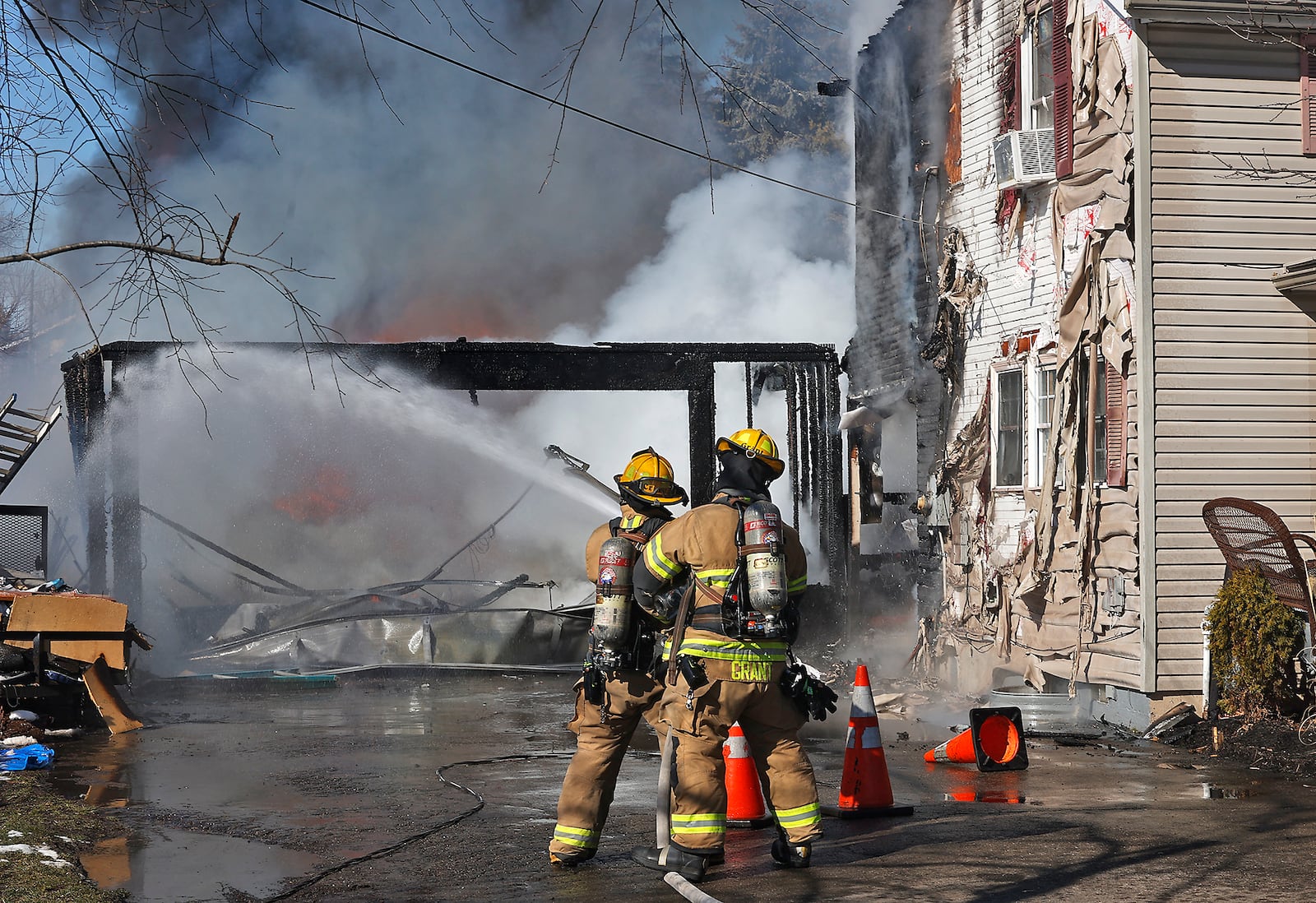 The Springfield Fire Rescue Division battled a house fire at a residence in the 900 block of Emery Street Monday, Feb. 19, 2024. The fire appeared to start in an attached garages and quickly spread to the two story residence. Fire crews arrived to find flames and smoke billowing from the garage and rear of the house. Two residents were home at the time of the fire and were uninjured. The cause of the fire is under investigation. BILL LACKEY/STAFF