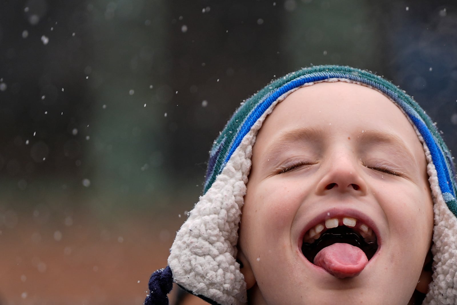 A child catches snowflakes with their tongue during El Museo del Barrio's 47th annual Three Kings Day parade, Monday, Jan. 6, 2025, in New York. (AP Photo/Julia Demaree Nikhinson)