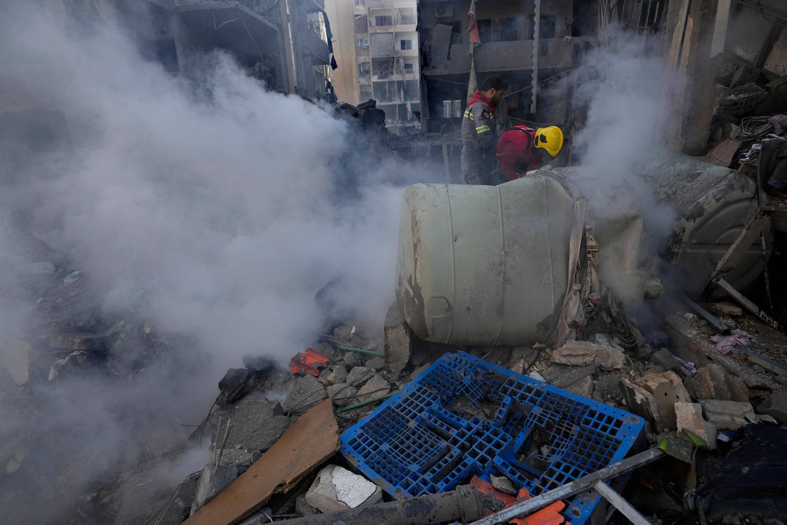 Rescue workers search for victims at the site of an Israeli airstrike that hit central Beirut, Lebanon, Saturday, Nov. 23, 2024. (AP Photo/Hussein Malla)