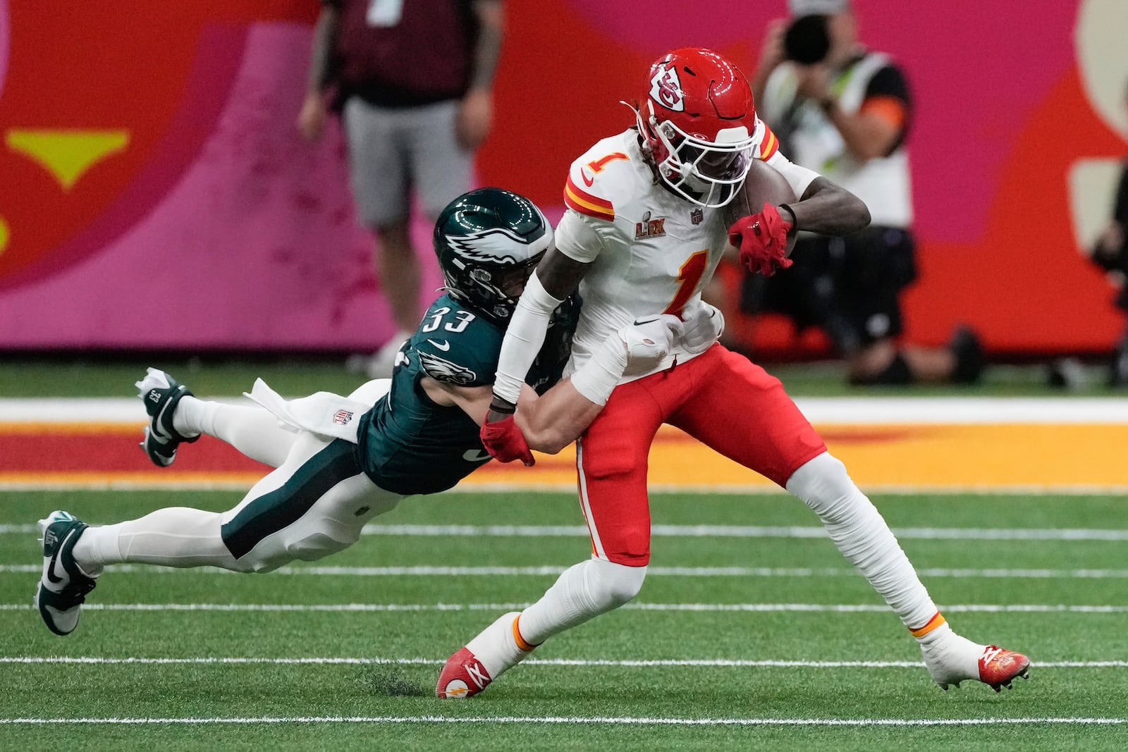 Kansas City Chiefs wide receiver Xavier Worthy (1) is tackled by Philadelphia Eagles defensive back Cooper DeJean (33) during the first half of the NFL Super Bowl 59 football game, Sunday, Feb. 9, 2025, in New Orleans. (AP Photo/Stephanie Scarbrough)