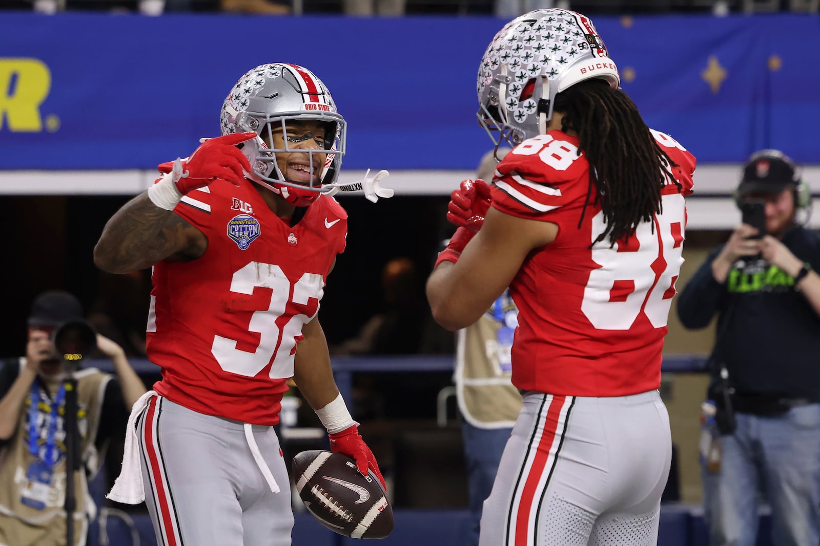 Ohio State running back TreVeyon Henderson (32) is congratulated by tight end Gee Scott Jr. (88) after scoring against Texas during the first half of the Cotton Bowl College Football Playoff semifinal game, Friday, Jan. 10, 2025, in Arlington, Texas. (AP Photo/Gareth Patterson)