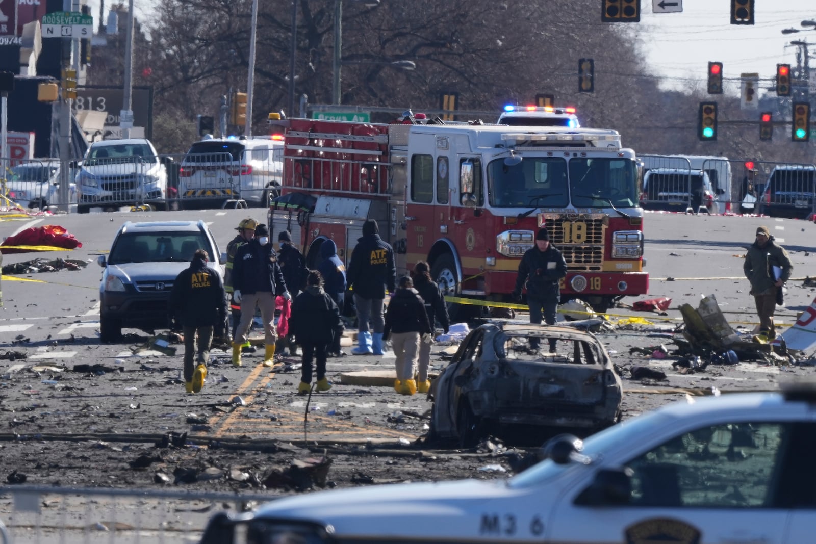 Investigators work the scene where a small plane crashed in Philadelphia, Saturday, Feb. 1, 2025. (AP Photo/Matt Rourke)