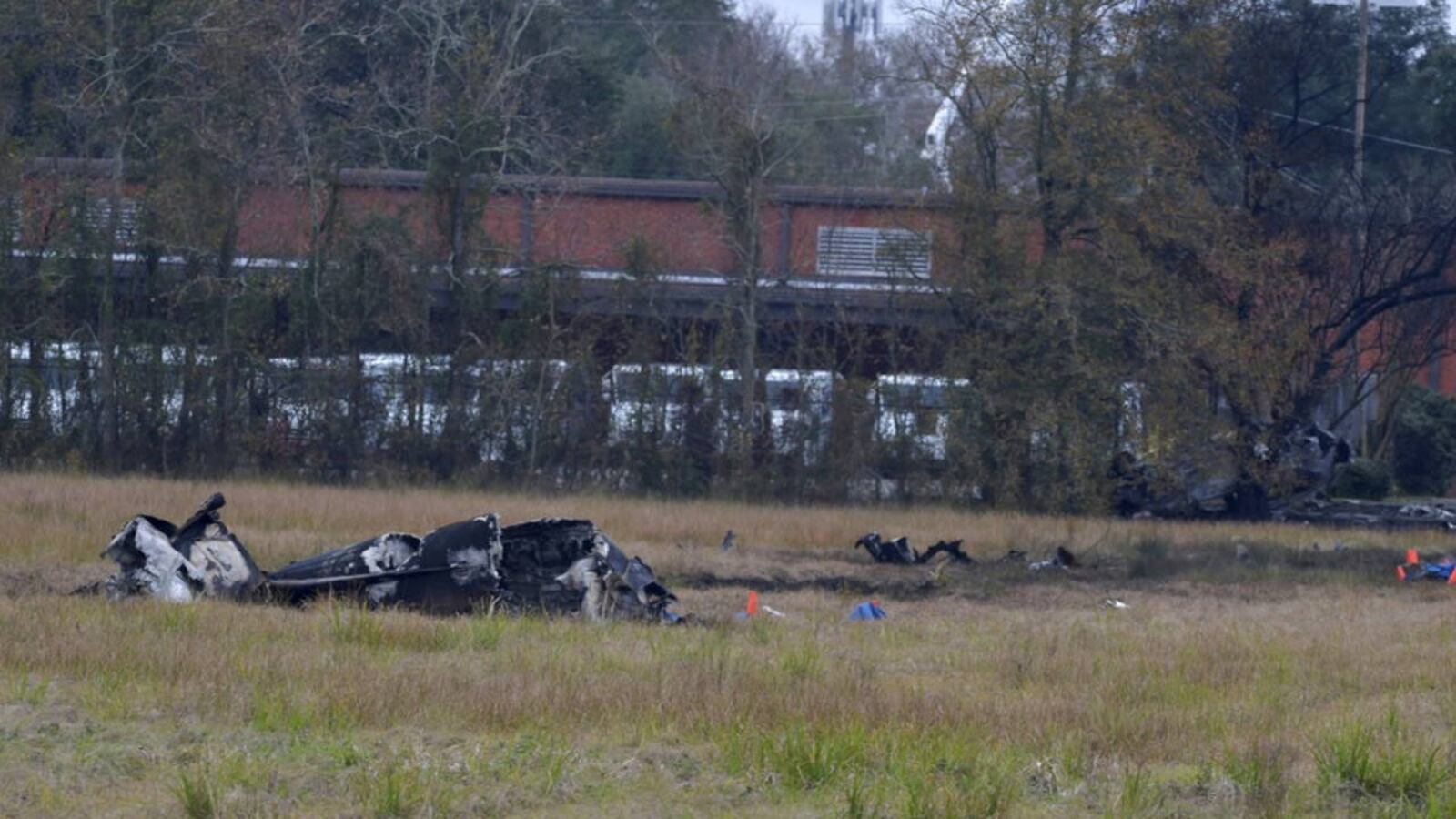 The charred wreckage of a plane lies in a field in Lafayette, Louisiana, Saturday morning.