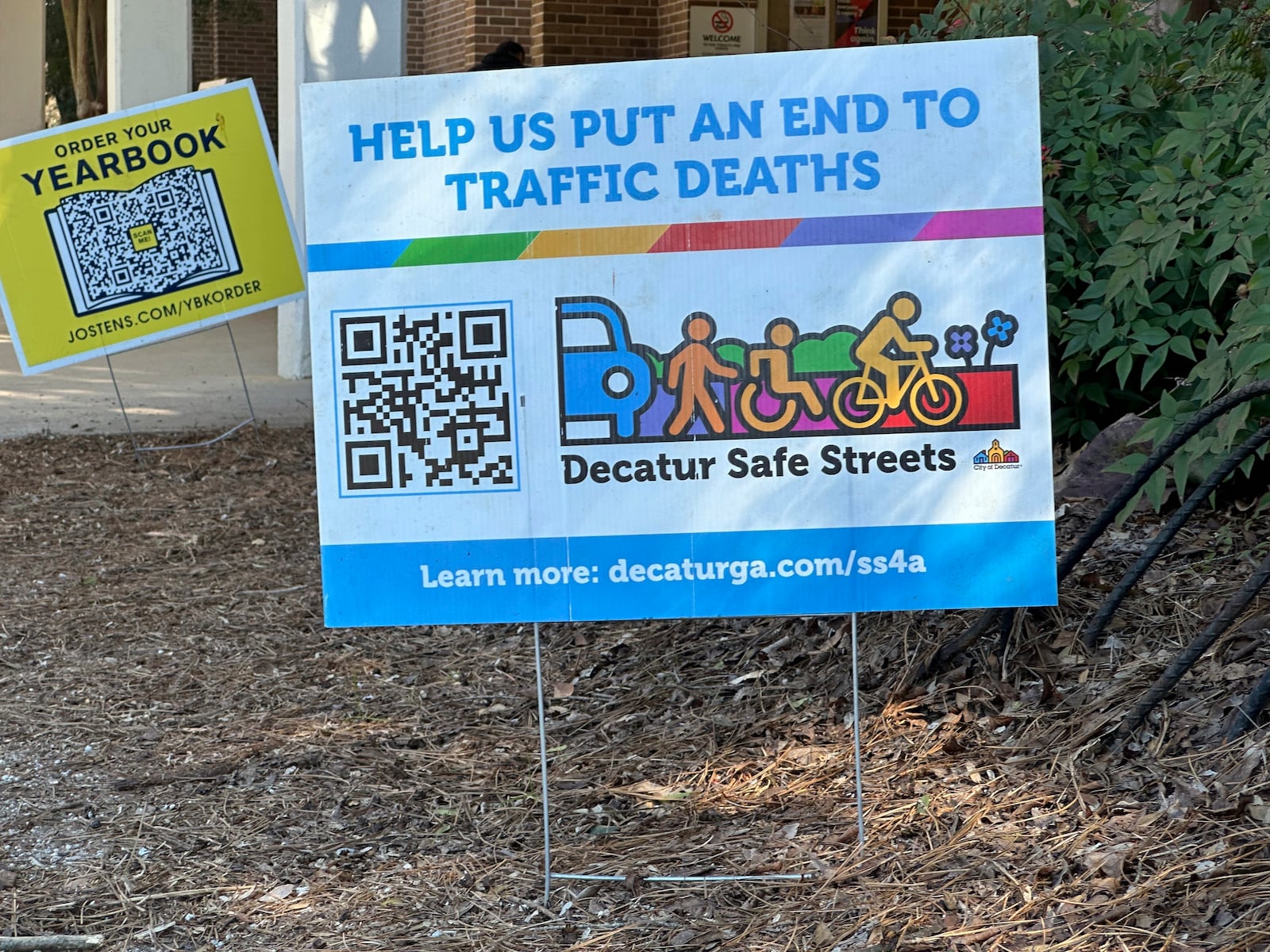 A sign promotes pedestrian and cyclist safety outside Beacon Hill Middle School in Decatur, Ga., on Tuesday, Feb. 25, 2025. (AP Photo/Jeff Amy)