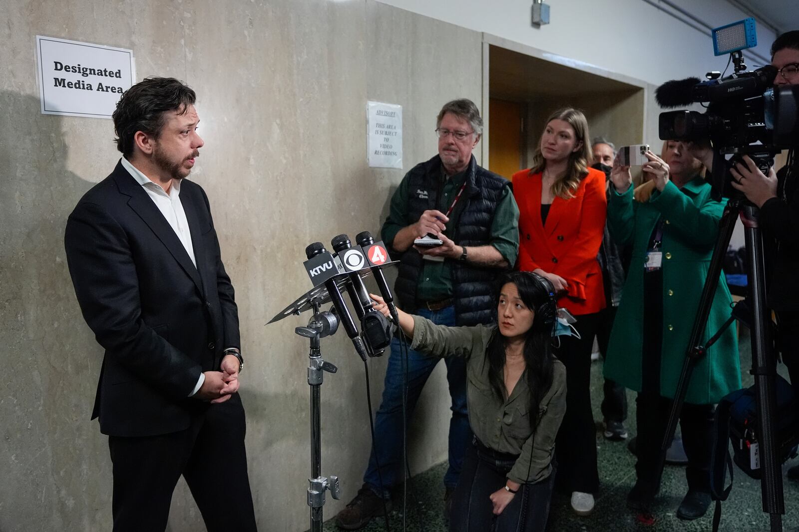 Timothy Oliver Lee, left, brother of Cash App founder Bob Lee, talks to reporters in the Hall of Justice after closing arguments by the prosecution for the murder trial of Nima Momeni, Monday, Dec. 2, 2024, in San Francisco. (AP Photo/Godofredo A. Vásquez)