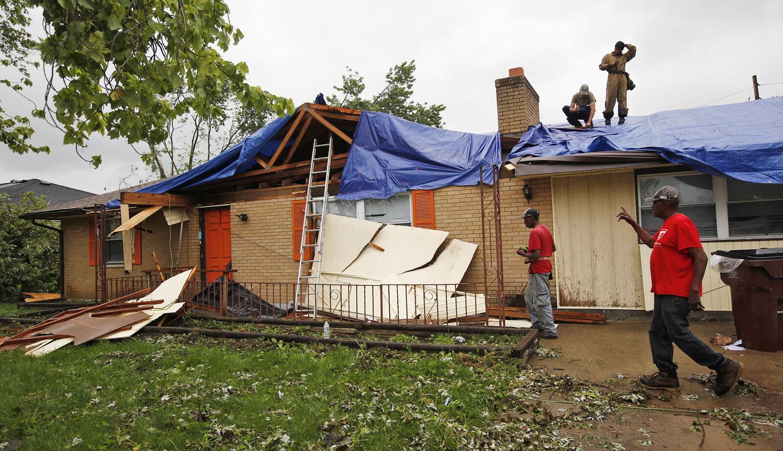 Families are trying to handle storm cleanup in Trotwood and other cities, while also handling logistical hurdles for getting their kids back to school. TY GREENLEES / STAFF