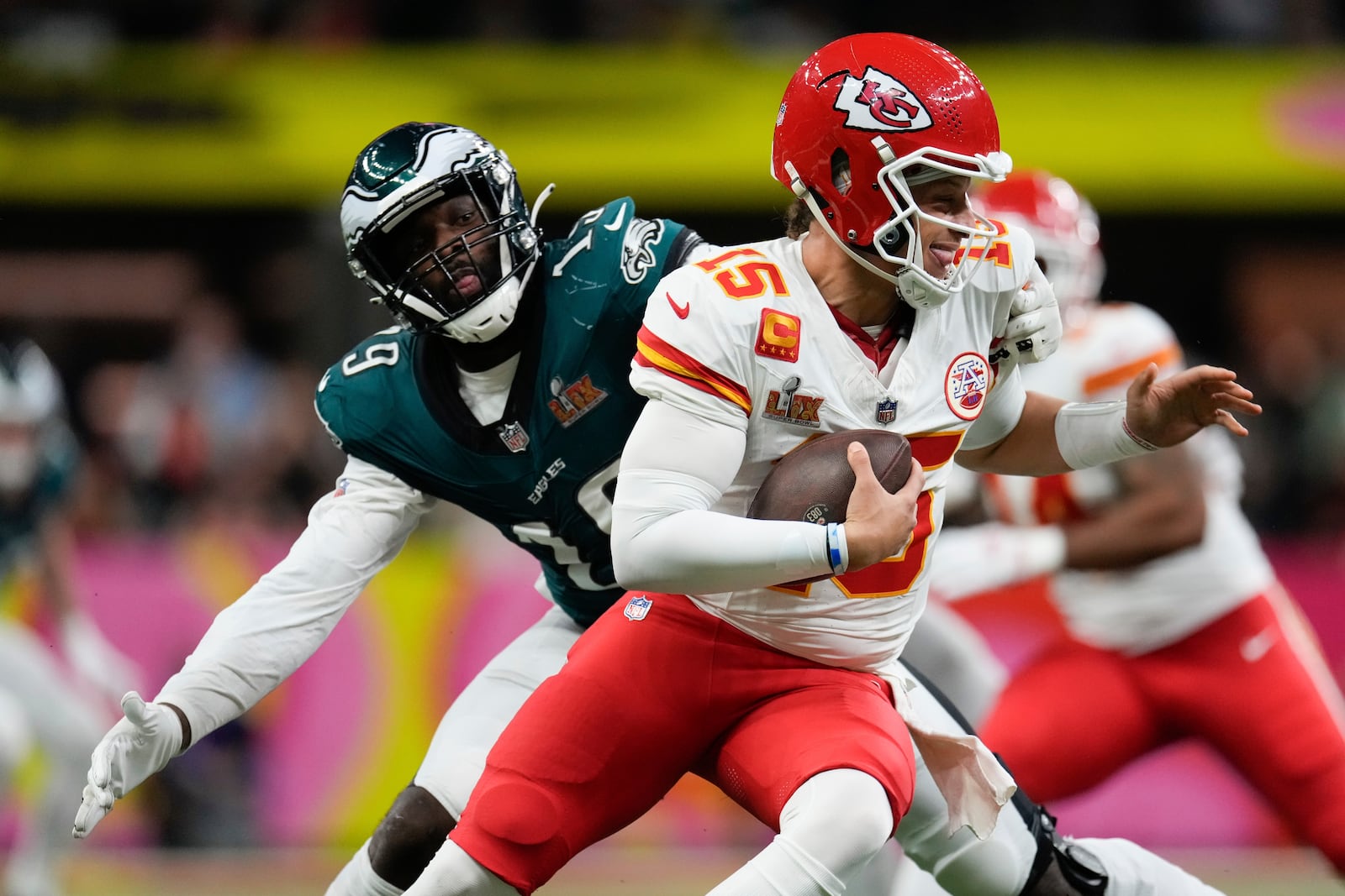 Kansas City Chiefs quarterback Patrick Mahomes (15) escapes the grasp of Philadelphia Eagles linebacker Josh Sweat (19) during the first half of the NFL Super Bowl 59 football game, Sunday, Feb. 9, 2025, in New Orleans. (AP Photo/George Walker IV)