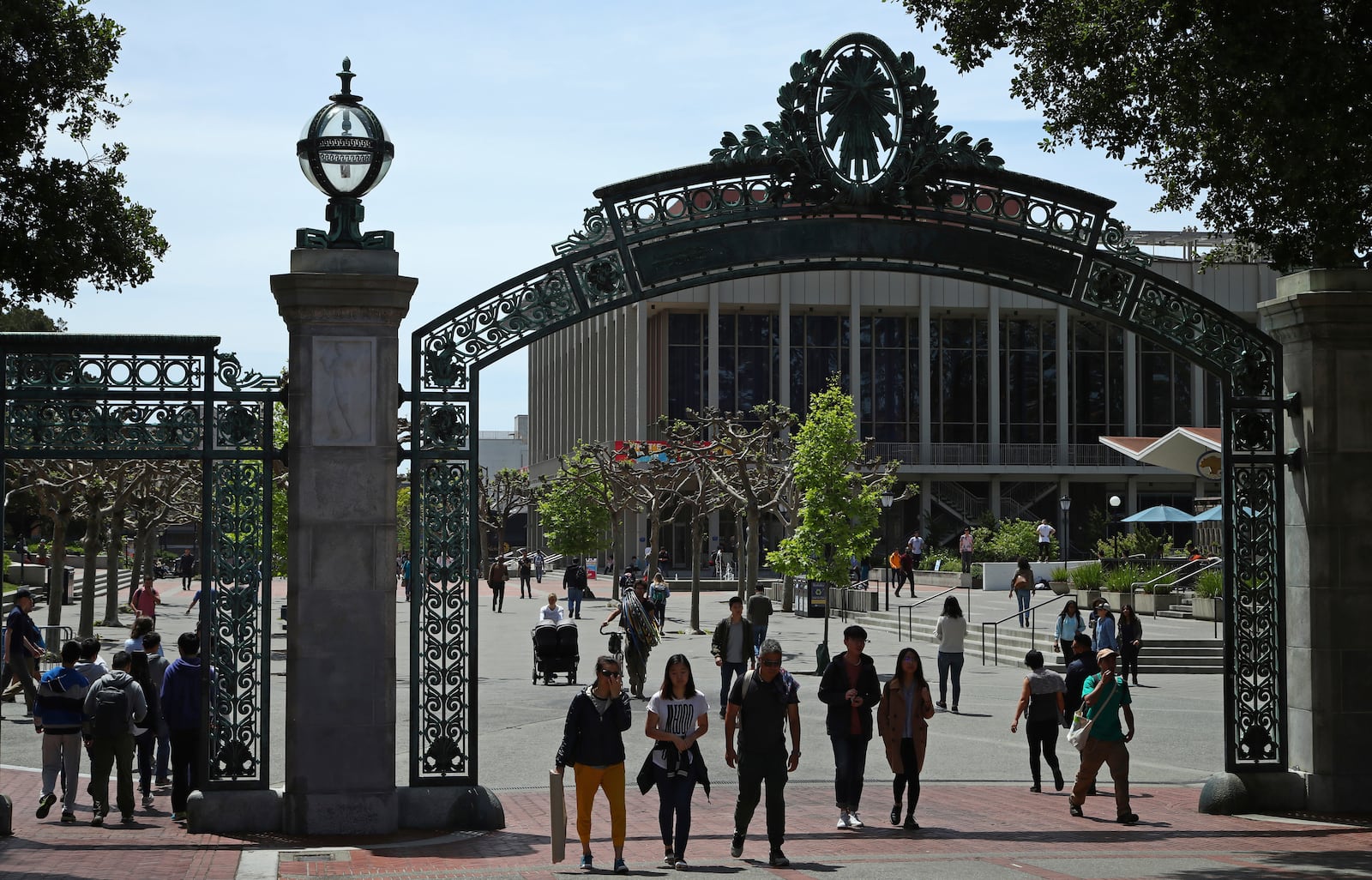 FILE - Students walk past Sather Gate on the University of California at Berkeley campus in Berkeley, Calif., May 10, 2018. (AP Photo/Ben Margot, File)