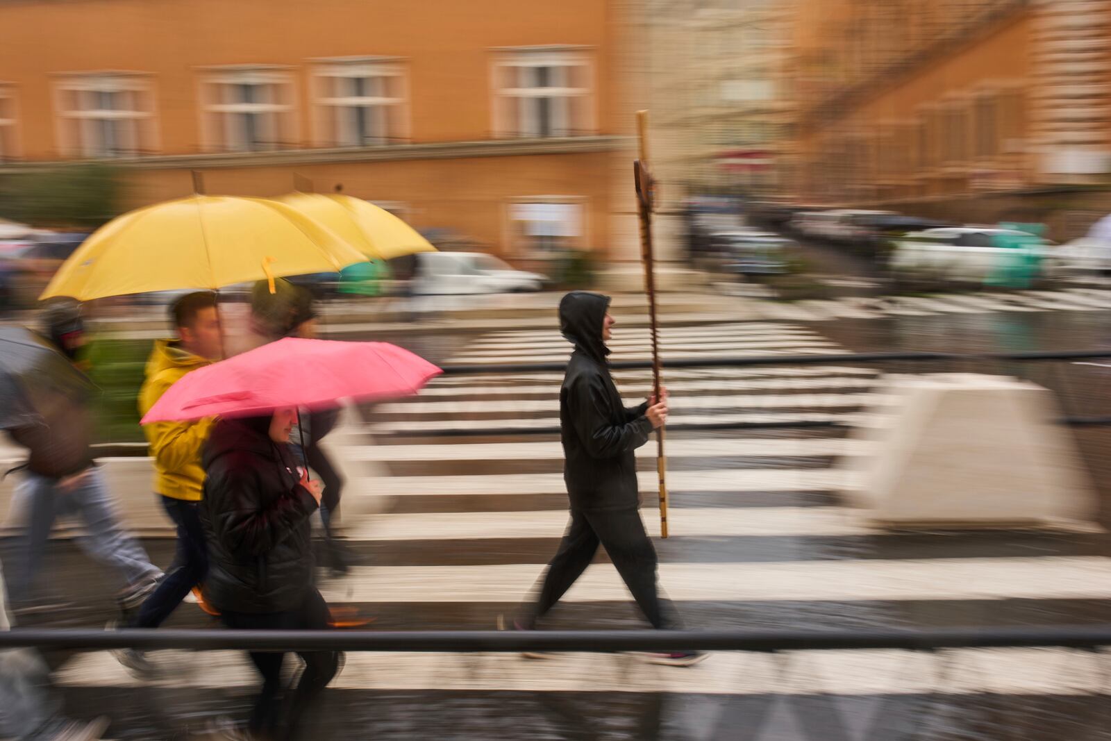 Catholic worshippers walk towards St. Peter's Square on a rainy day in Rome, Wednesday, March 12, 2025. (AP Photo/Francisco Seco)