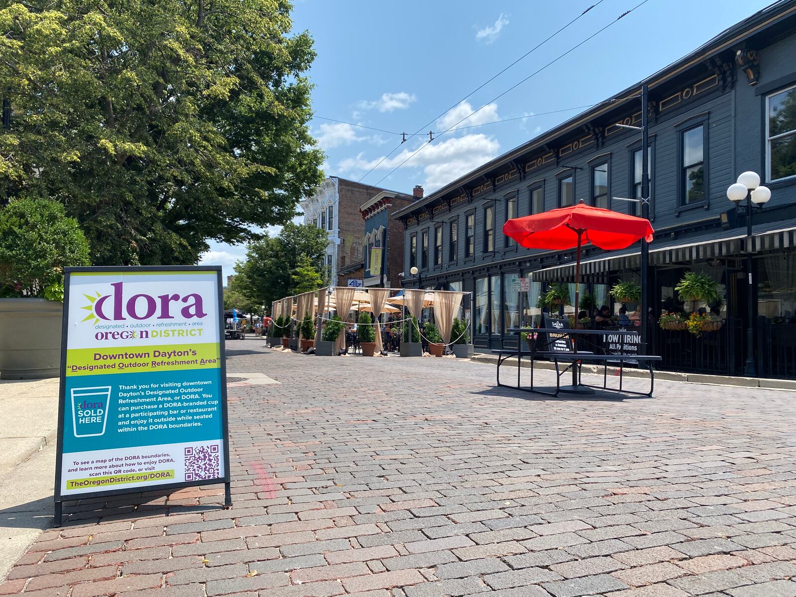 The sign for the outdoor drinking area in the Oregon District. Eileen McClory / Staff