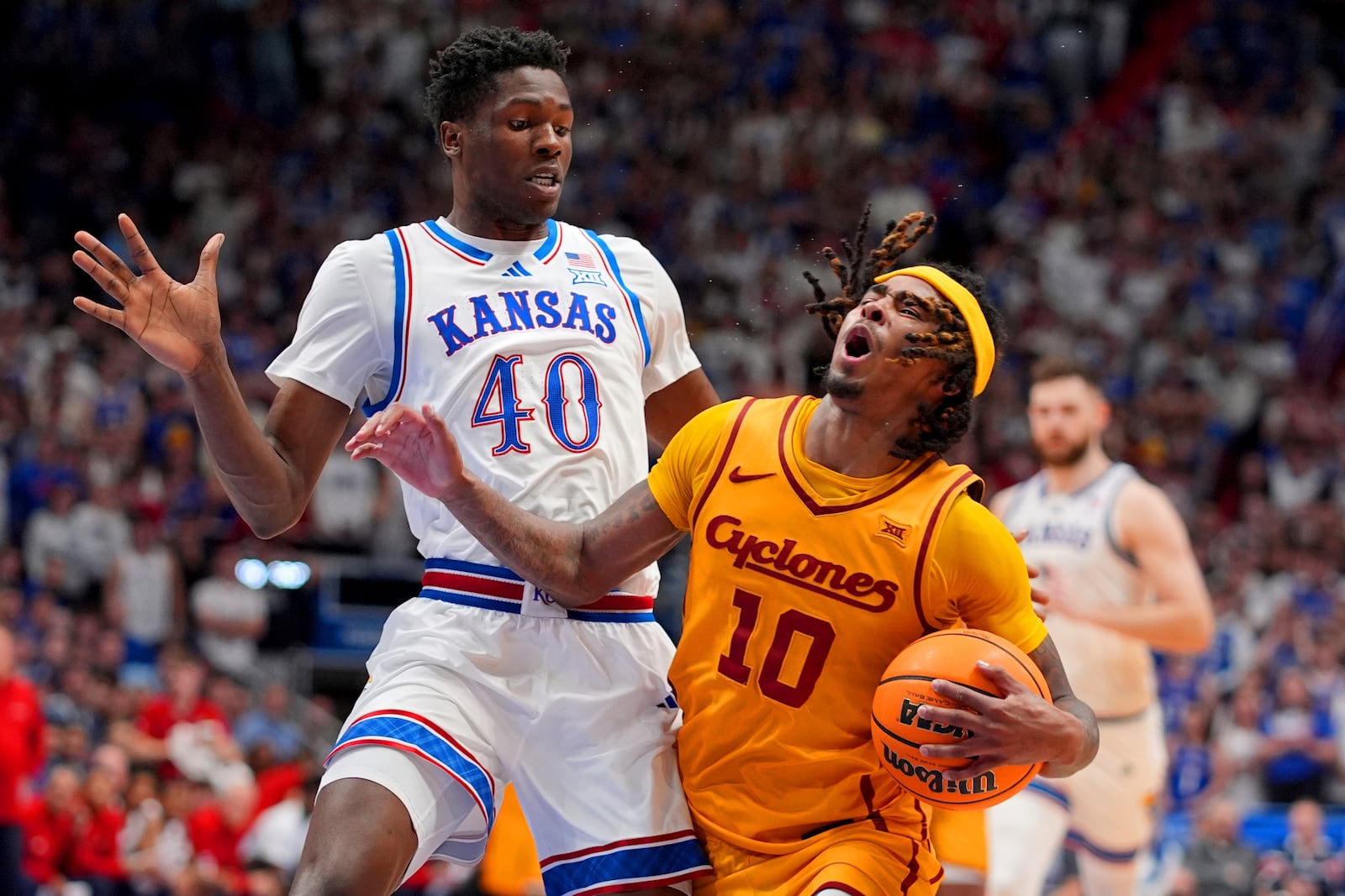 Kansas forward Flory Bidunga (40) pressures Iowa State guard Keshon Gilbert (10) as he drives during the second half of an NCAA college basketball game, Monday, Feb. 3, 2025, in Lawrence, Kan. (AP Photo/Charlie Riedel)