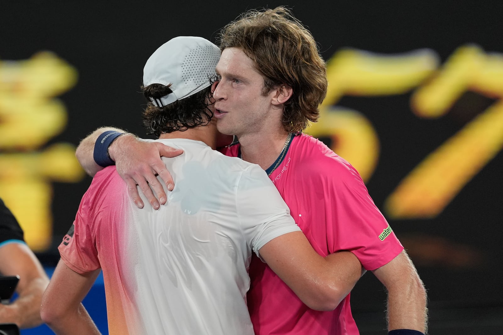 Joao Fonseca of Brazil is congratulated by Andrey Rublev, right, of Russia following their first round match at the Australian Open tennis championship in Melbourne, Australia, Tuesday, Jan. 14, 2025. (AP Photo/Asanka Brendon Ratnayake)