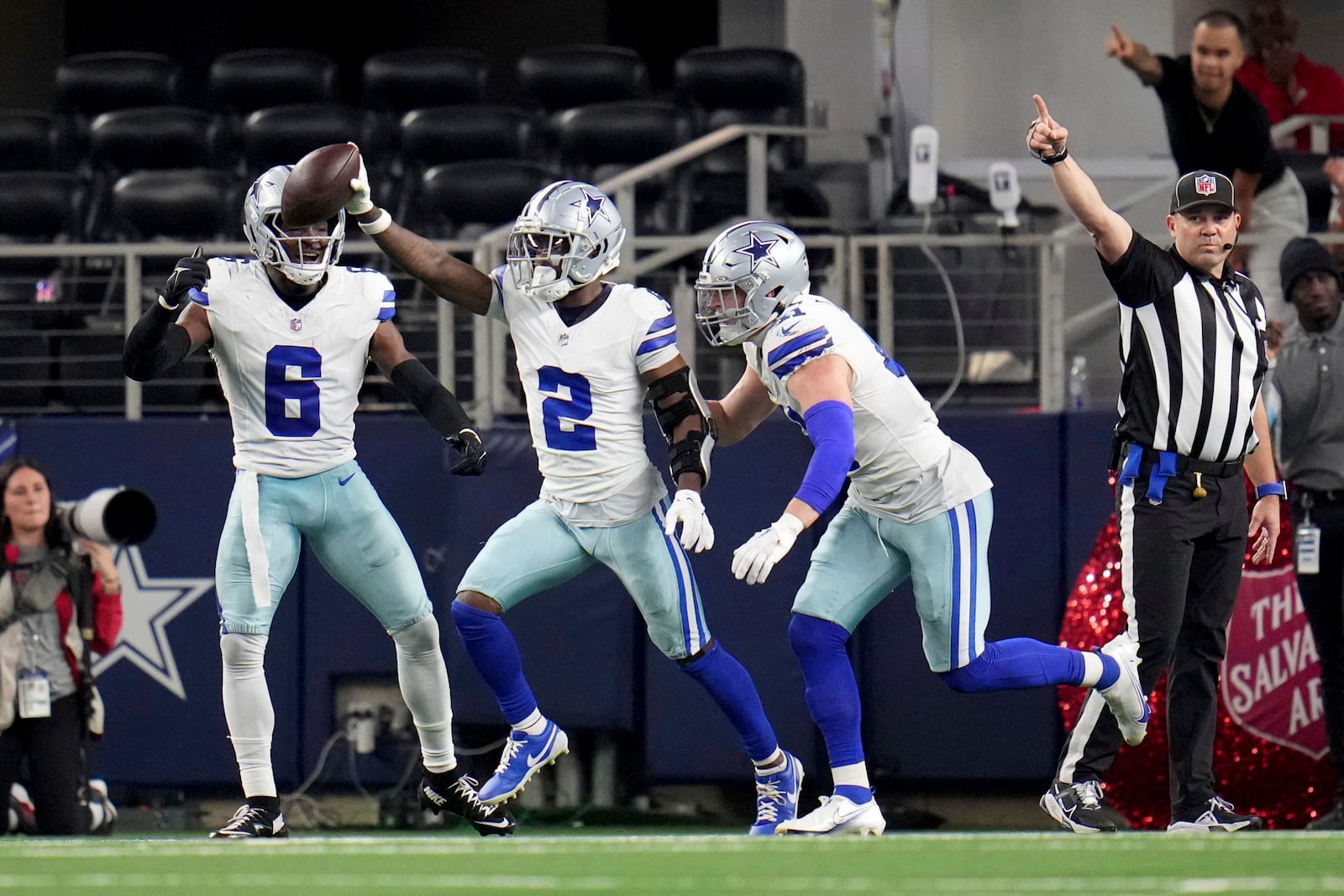 Dallas Cowboys cornerback Jourdan Lewis (2), Donovan Wilson (6) and Nick Vigil, right, celebrate Lewis' interception in t he second half of an NFL football game against the Tampa Bay Buccaneers in Arlington, Texas, Sunday, Dec. 22, 2024. (AP Photo/Julio Cortez)