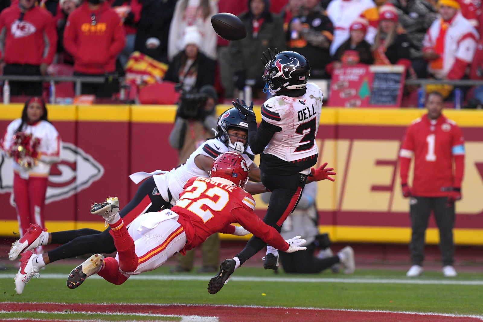 Houston Texans wide receiver Tank Dell (3) catches a touchdown pass as Kansas City Chiefs cornerback Trent McDuffie (22) defends during the second half of an NFL football game Saturday, Dec. 21, 2024, in Kansas City, Mo. Dell was injured on the play. (AP Photo/Charlie Riedel)