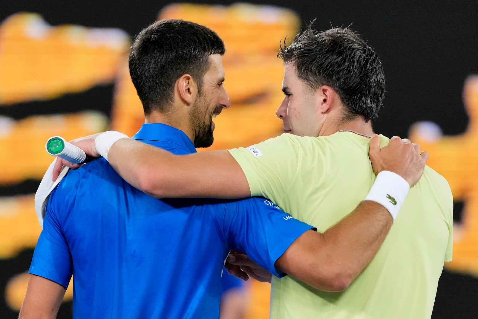 Novak Djokovic, left, of Serbia is congratulated by Jaime Faria of Portugal following their second round match at the Australian Open tennis championship in Melbourne, Australia, Wednesday, Jan. 15, 2025. (AP Photo/Vincent Thian)