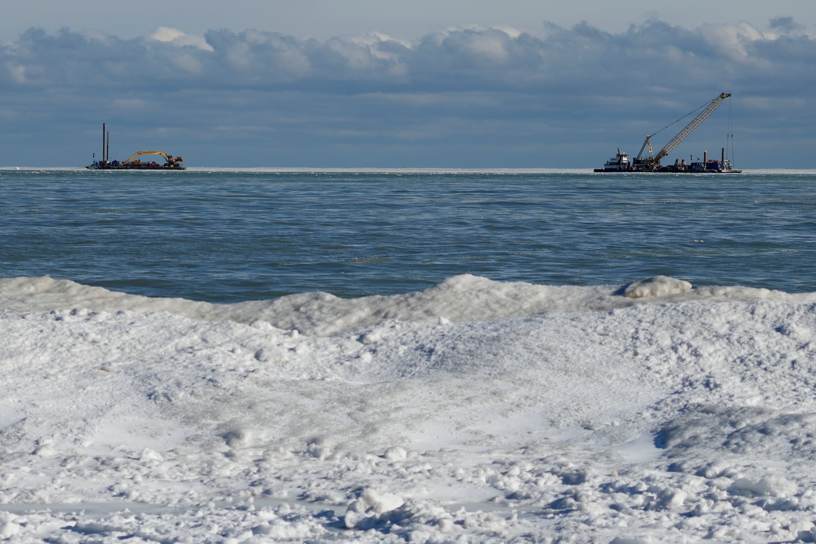 Snow covers the shore of Lake Michigan during cold weather in Evanston, Ill., Wednesday, Jan. 8, 2025. (AP Photo/Nam Y. Huh)