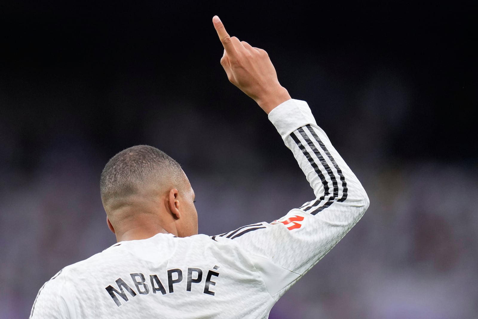 Real Madrid's Kylian Mbappe celebrates after scoring his side's opening goal during the Spanish La Liga soccer match between Real Madrid and Rayo Vallecano at the Santiago Bernabeu stadium in Madrid, Spain, Sunday, March 9, 2025. (AP Photo/Manu Fernandez)