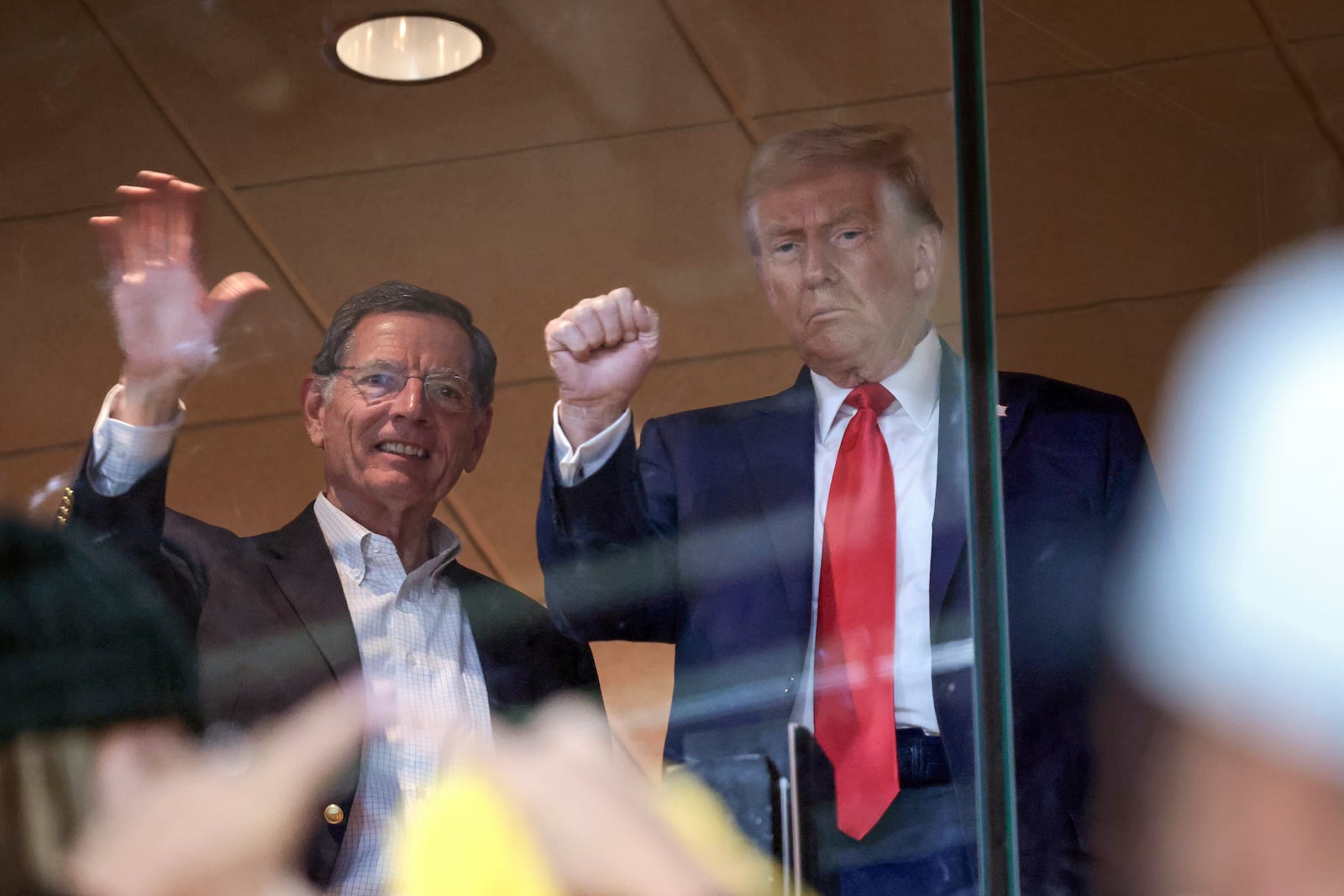 Republican presidential nominee former President Donald Trump attends the Pittsburgh Steelers game against the New York Jets Sunday, Oct. 20, 2024, in Pittsburgh, with Sen. John Barrasso, R-Wyo. (Win McNamee/Pool via AP)