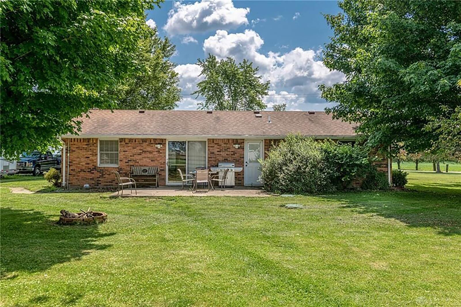 A concrete patio is off the kitchen in the back yard, and there is a brick firepit as well. CONTRIBUTED PHOTO