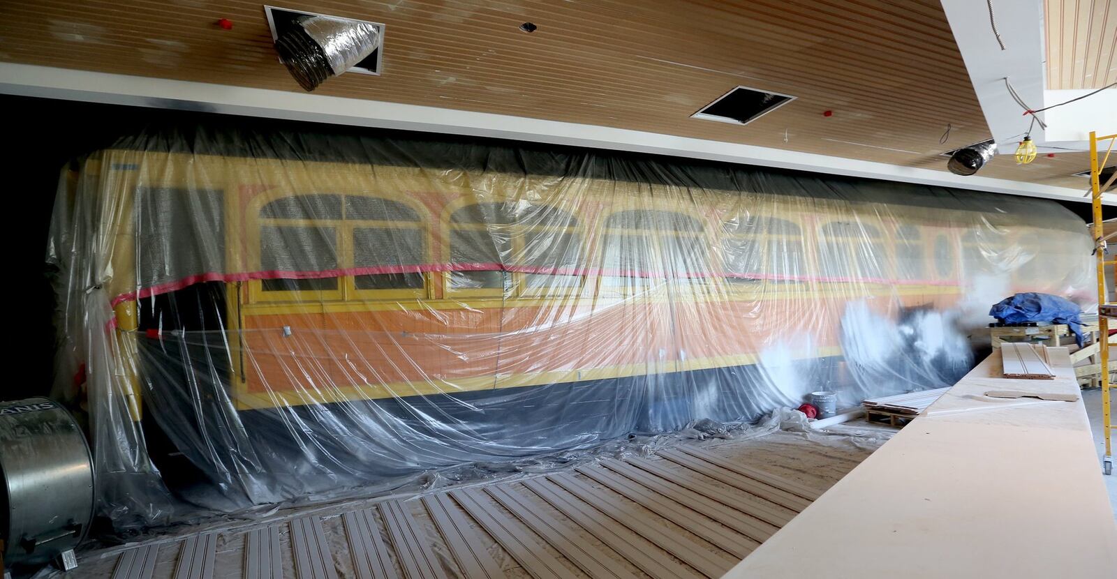 A restored 1903 Barney & Smith interurban car, under wraps during construction, will be the centerpiece of the reimagined Culp’s Café in the new Winsupply Center of Leadership at Carillon Historical Park. LISA POWELL / STAFF