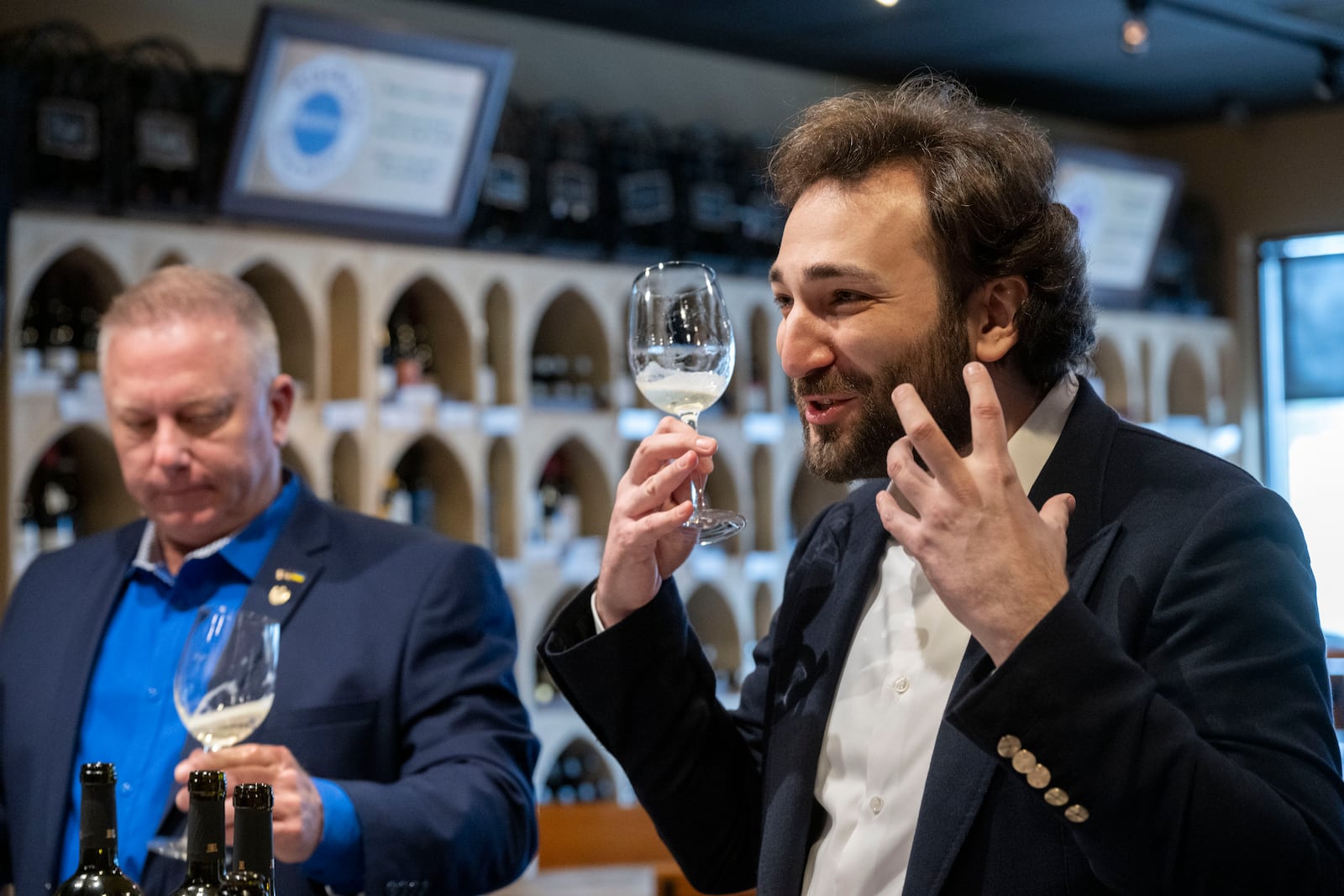 Giorgi Iukuridze, owner and CEO Shabo, a Ukrainian winery, right, describes his wine during a tasting with Joseph Belli, Sales Manager for SPYRT Worldwide, at Wine Styles, in Dumfries, Va., Dec. 20, 2024. (AP Photo/Kevin Wolf)