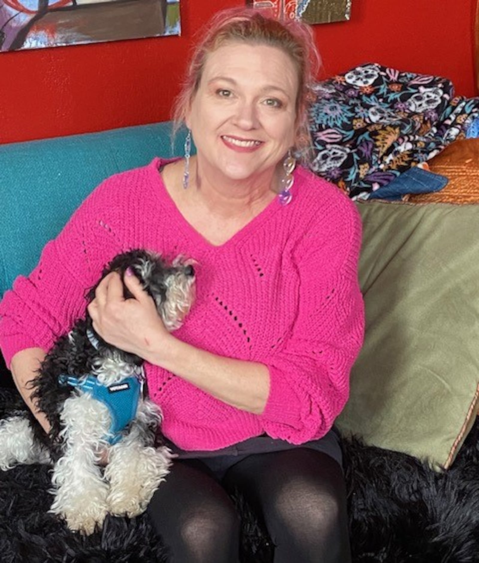 McPherson Town resident Kristen Wicker, with her poodle pup Kizmet, mixes bright colors, local art and many mementos to create character in her one-bedroom condo. CONTRIBUTED BY BARBARA MACKEY BYRD