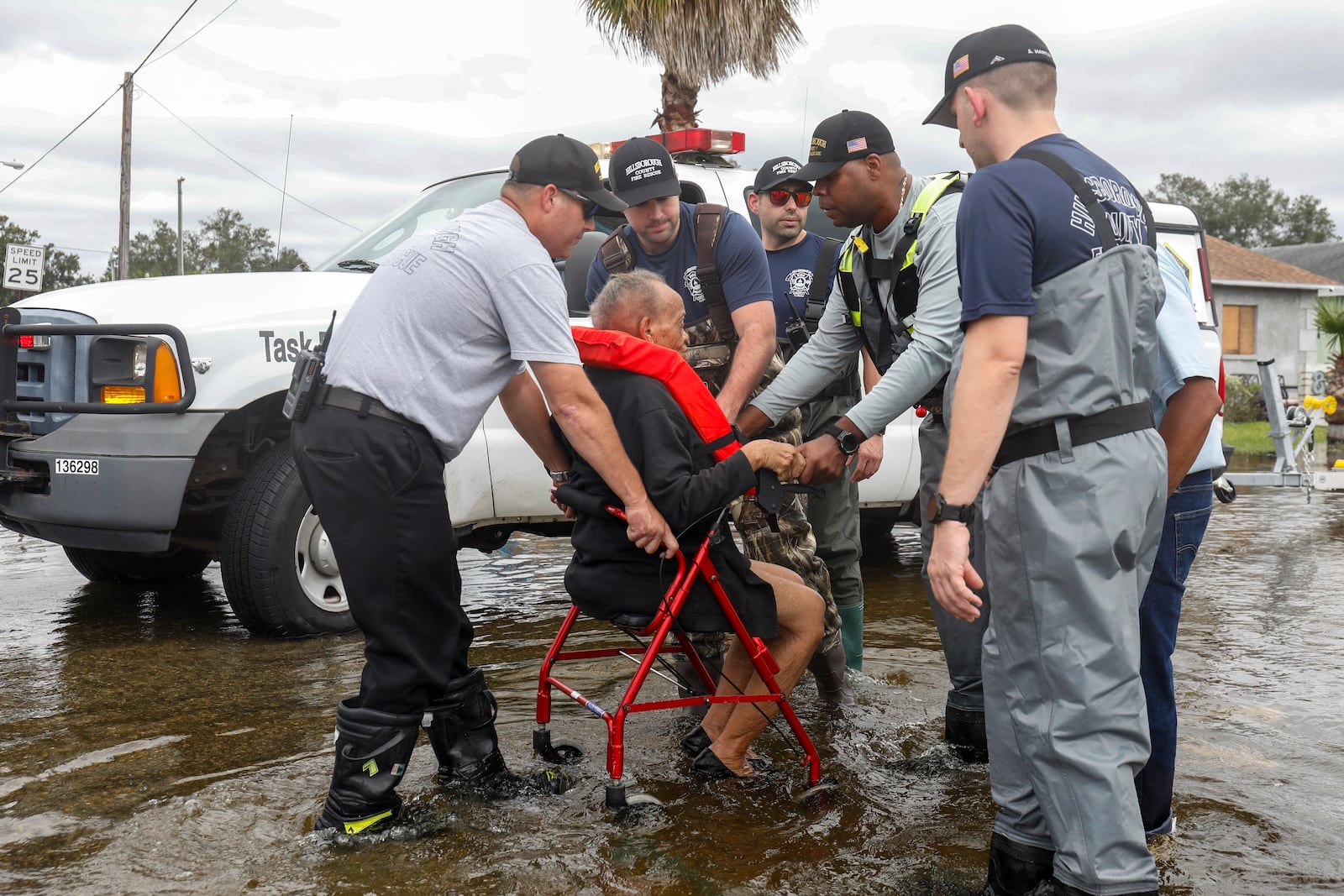 Hillsborough County fire and rescue assist local residents from their flooded homes on Thursday, Oct. 10, 2024, in Progress Village Community. (Jefferee Woo/Tampa Bay Times via AP)