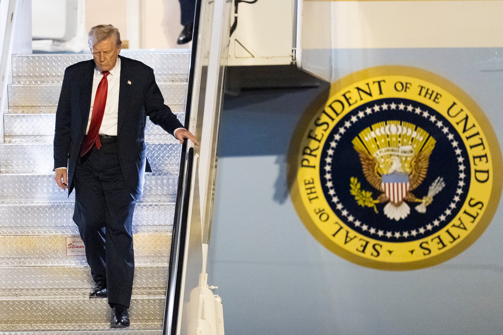 President Donald Trump arrives on Air Force One at Palm Beach International Airport, Friday, March 14, 2025, in West Palm Beach, Fla. (AP Photo/Manuel Balce Ceneta)