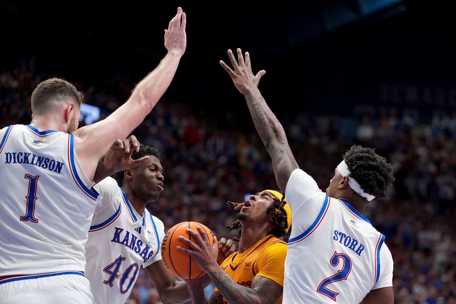 Iowa State guard Keshon Gilbert looks to shoot under pressure from Kansas center Hunter Dickinson (1), forward Flory Bidunga (40) and guard AJ Storr (2) during the second half of an NCAA college basketball game, Monday, Feb. 3, 2025, in Lawrence, Kan. (AP Photo/Charlie Riedel)