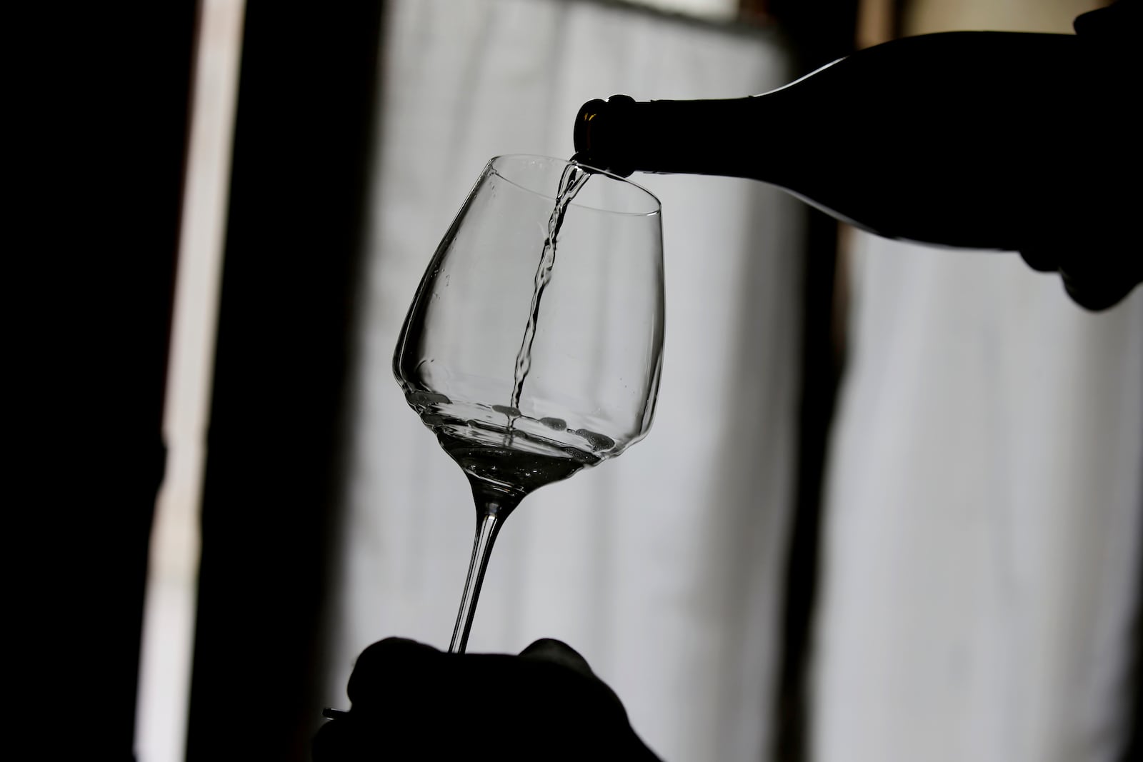 Wine grower Adelino Pizzobon spills a bottle of Prosecco during a wine tasting at the Case Paolin farm, in Volpago del Montello, Italy, Monday, Oct. 15, 2018. (AP Photo/Luca Bruno, File)