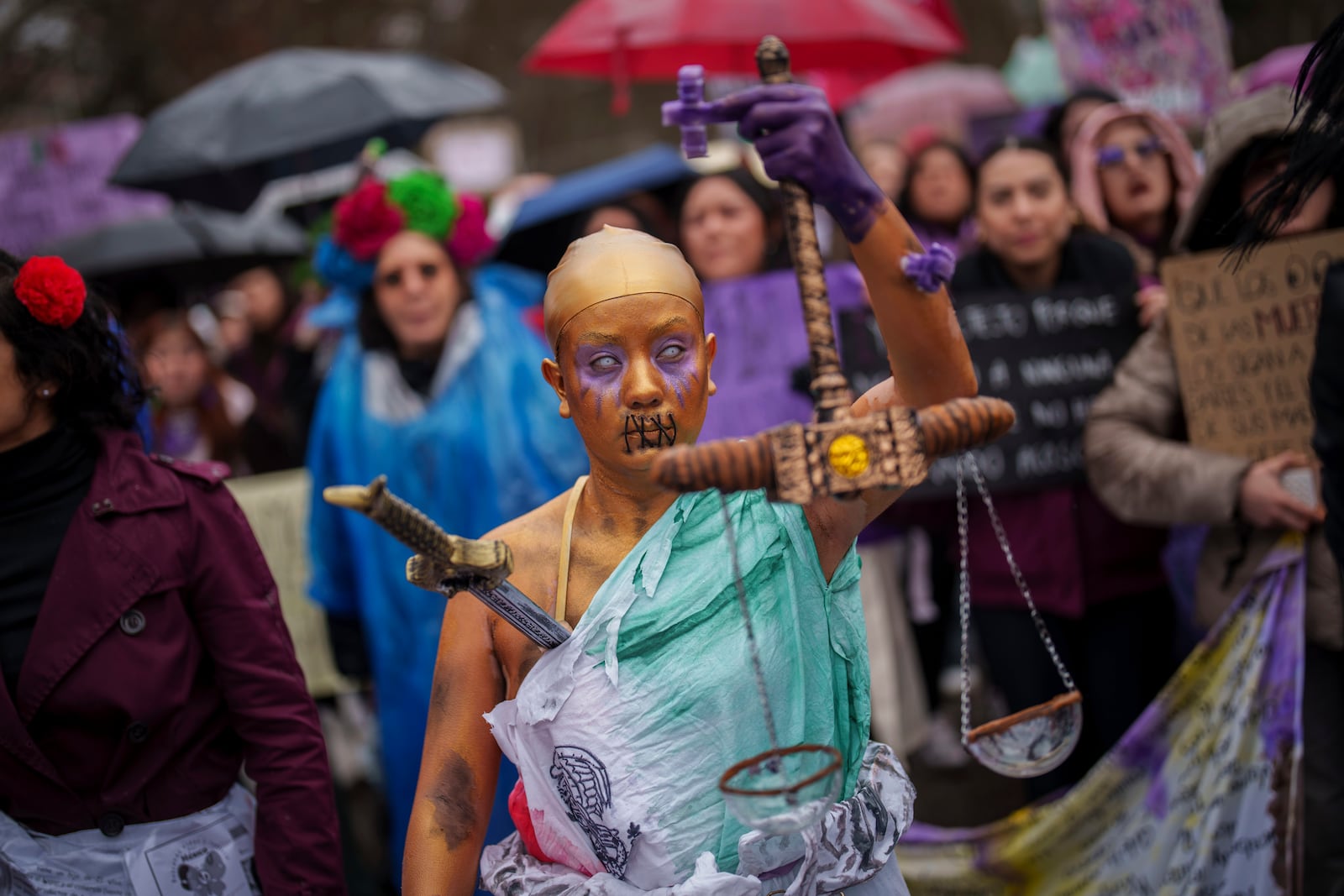 Demonstrators rally during an International Women's Day protest in Madrid, Spain, Saturday, March 8, 2025. (AP Photo/Bernat Armangue)