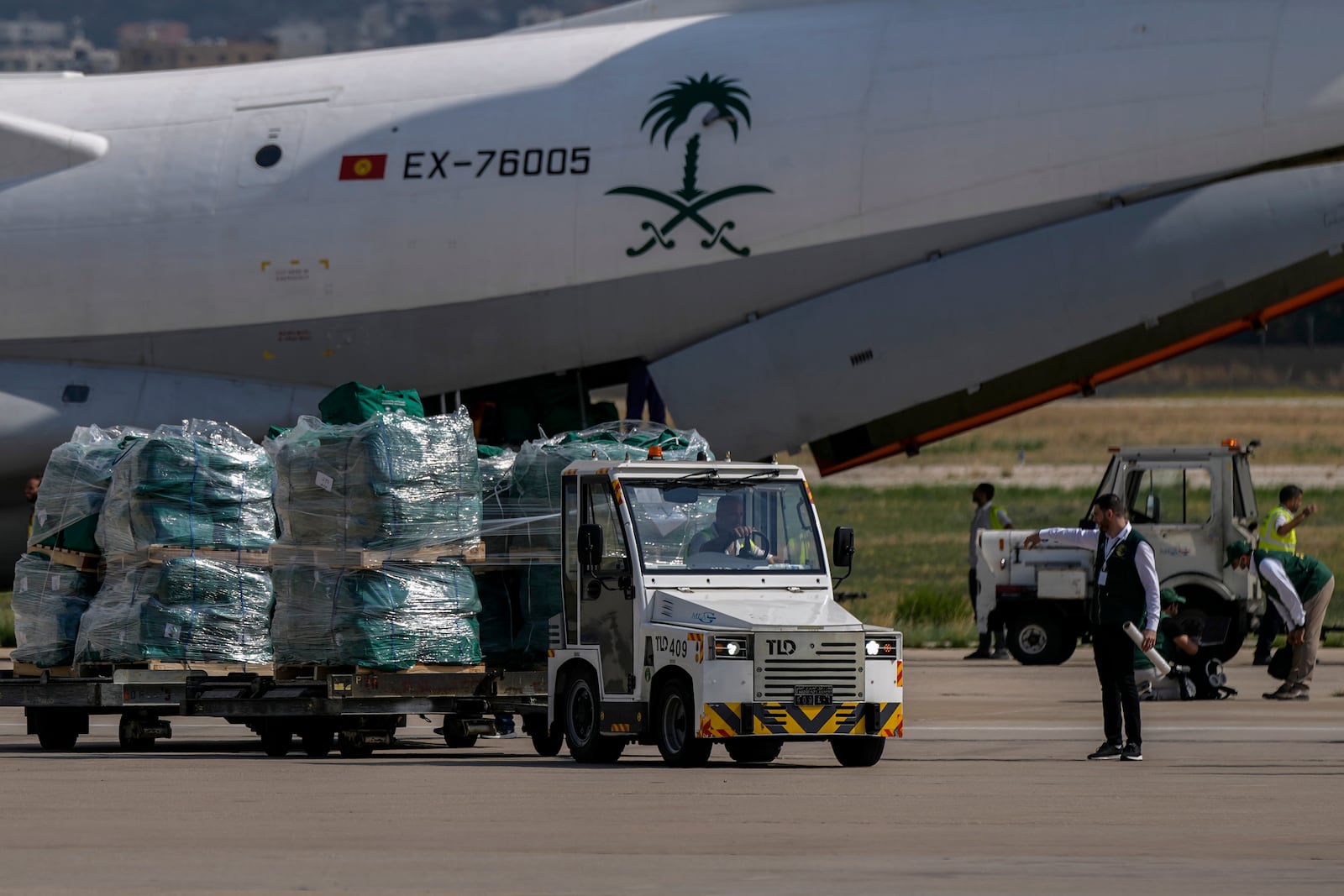 Workers unload Saudi medical aid boxes arriving at Beirut International airport, Lebanon, Sunday, Oct. 13, 2024. (AP Photo/Bilal Hussein)