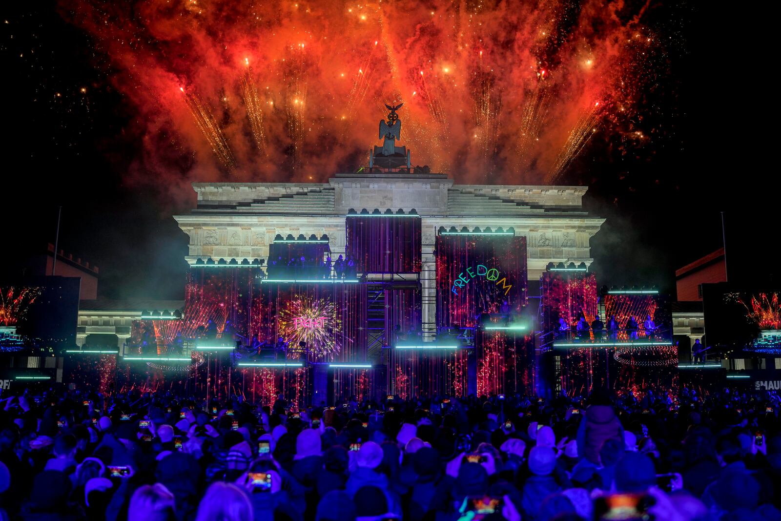 Fireworks light the sky during the as musicians play on stage during the concert for freedom for the 35th anniversary of the fall of the Berlin Wall, in Berlin, Germany, Saturday, Nov. 9, 2024. (AP Photo/Ebrahim Noroozi)