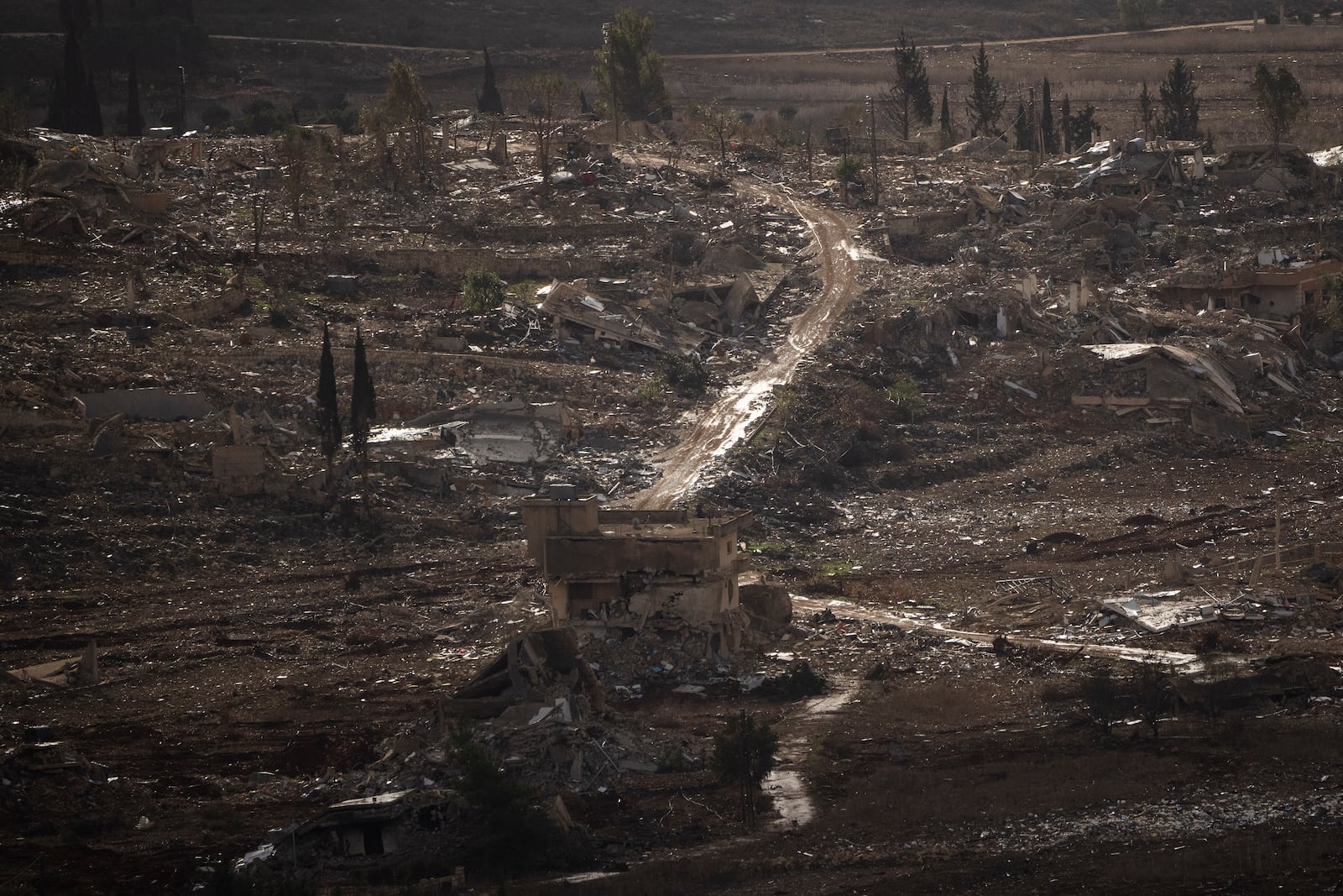 Destroyed buildings stand on an area of a village in southern Lebanon as seen from northern Israel, Monday, Nov. 25, 2024. (AP Photo/Leo Correa)