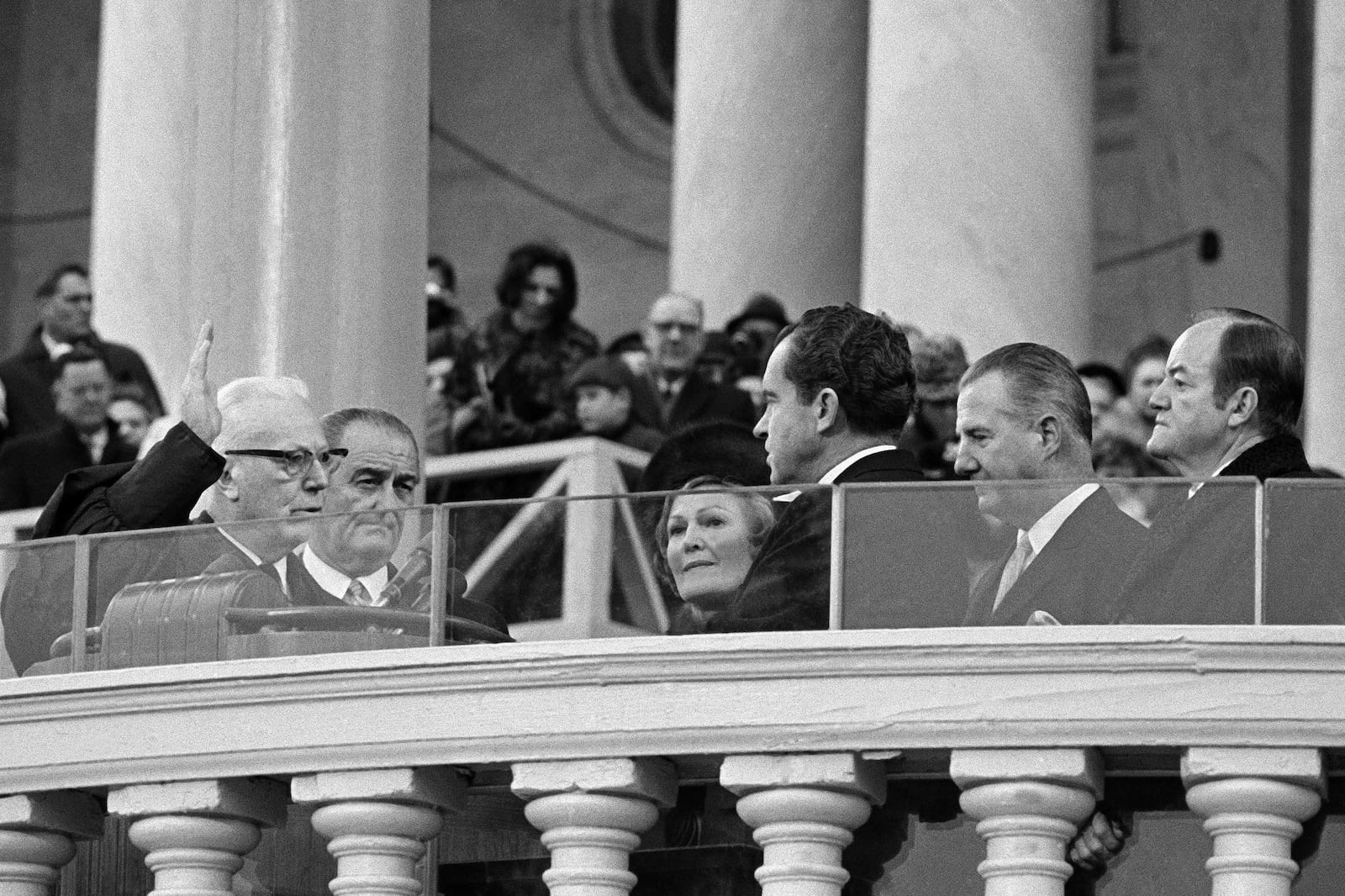 FILE - Outgoing Vice President Hubert Humphrey, right, watches Chief Justice Earl Warren administers the oath to President-elect Richard Nixon who is accompanied by his wife Pat, former President Lyndon Johnson, second left, and incoming Vice President Spiro T. Agnew, on the U.S. Capitol steps in Washington, Jan. 20, 1969. (AP Photo, File)