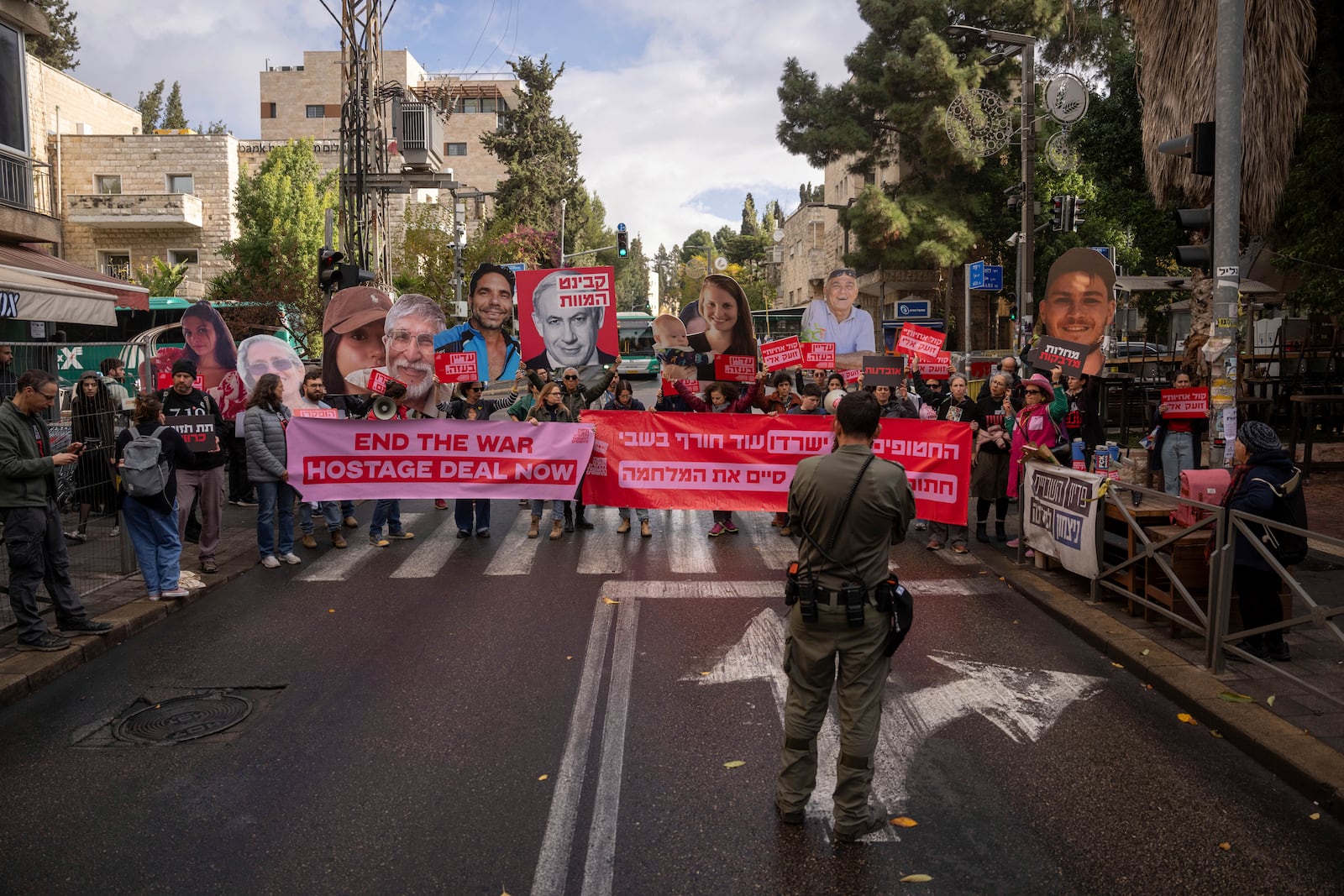 Families and supporters of Israeli hostages held by Hamas in Gaza, hold photos of their loved ones during a protest calling for their release outside the prime minister's house in Jerusalem, Monday, Nov. 18, 2024. (AP Photo/Ohad Zwigenberg)