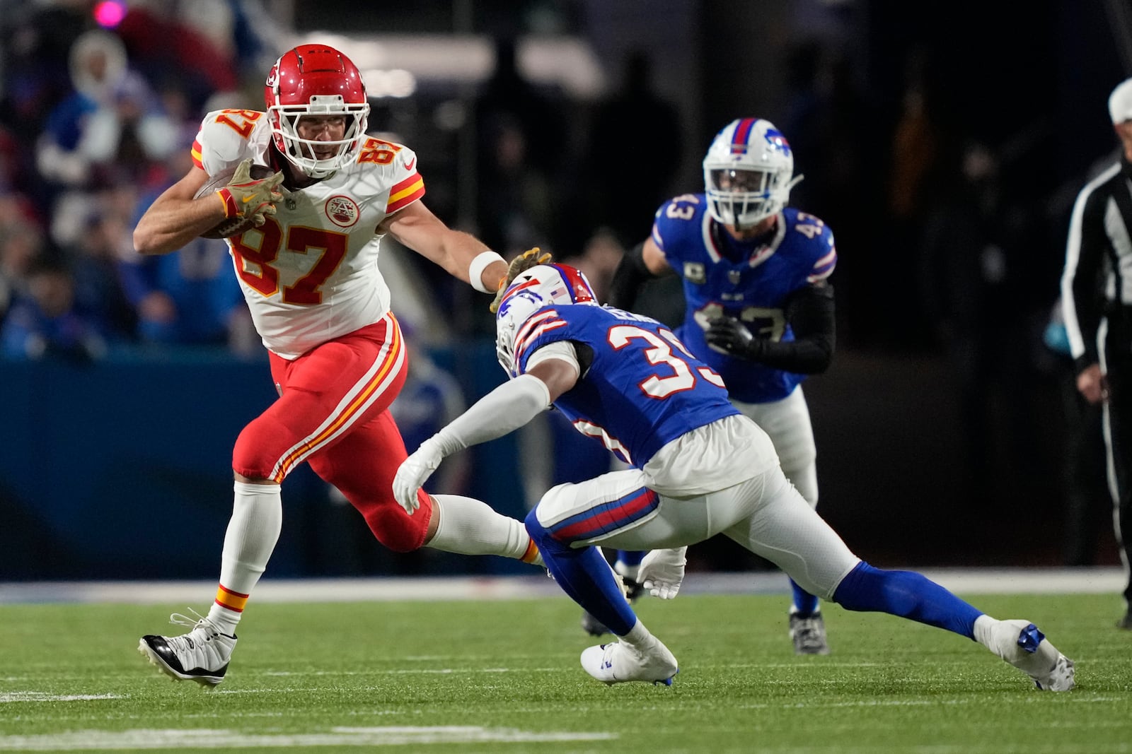 Kansas City Chiefs tight end Travis Kelce (87) runs with the ball as Buffalo Bills cornerback Cam Lewis defends during the second half of an NFL football game Sunday, Nov. 17, 2024, in Orchard Park, N.Y. (AP Photo/Julia Demaree Nikhinson)