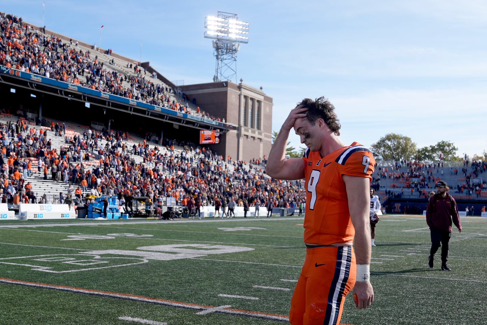 Illinois quarterback Luke Altmyer walks off the field after his team's 25-17 loss to Minnesota in an NCAA college football game Saturday, Nov. 2, 2024, in Champaign, Ill. (AP Photo/Charles Rex Arbogast)