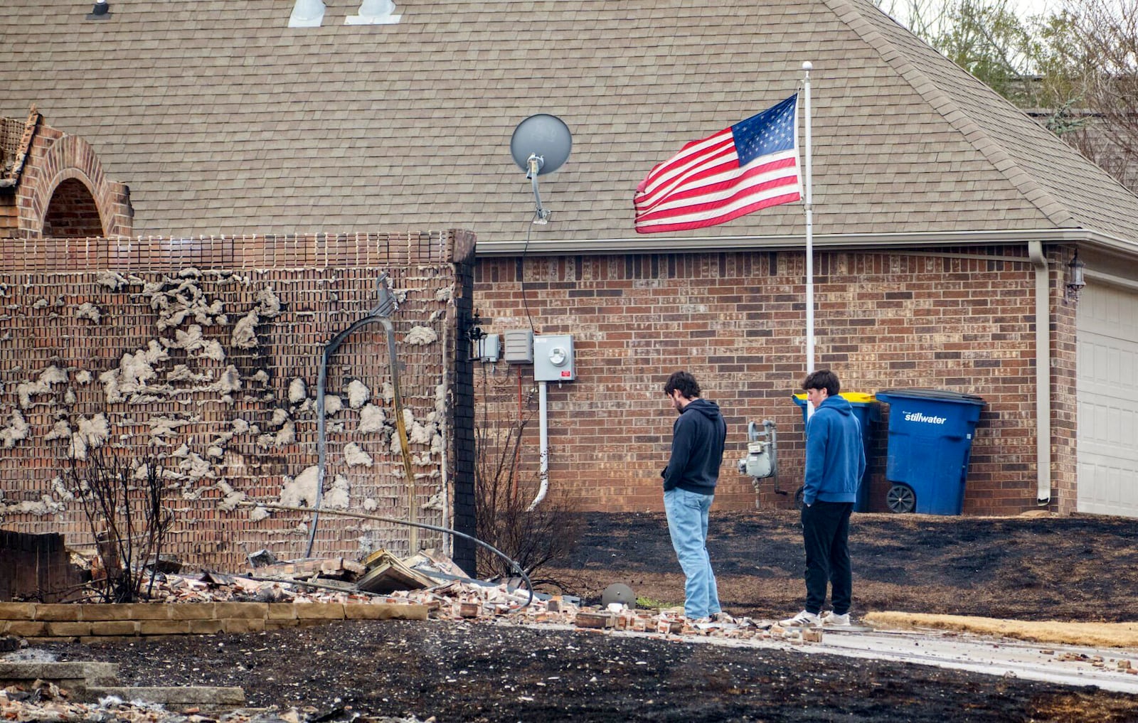 Stillwater, Okla., residents assesses the damage in the Crosswinds and Pecan Hill communities on Saturday, March 15, 2025, due to Friday's wildfires on the west side of town. (Jason Elmquist/The News Press via AP)