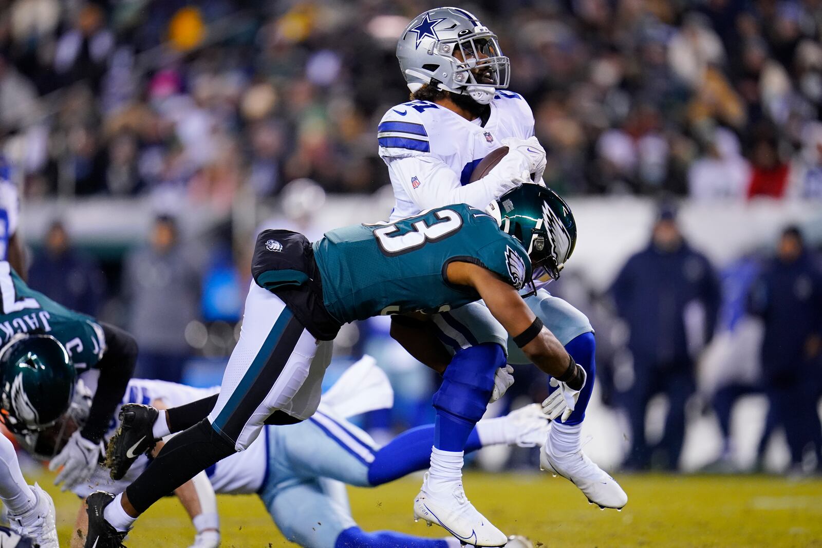 Dallas Cowboys running back Ezekiel Elliott is hit by Philadelphia Eagles' Josiah Scott during the first half of an NFL football game, Saturday, Jan. 8, 2022, in Philadelphia. (AP Photo/Julio Cortez)