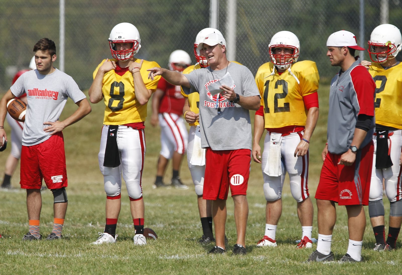 Wittenberg offensive coordinator Kevin Hoyng, center, reacts to a play during practice on Monday, Aug. 18, 2014, in Springfield. David Jablonski/Staff