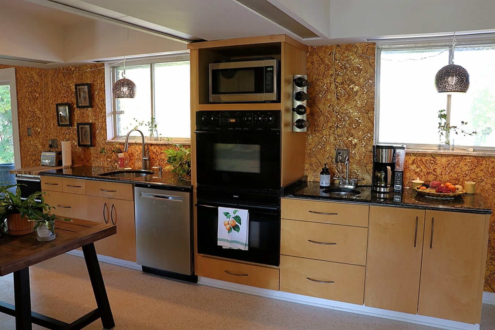 The galley kitchen has light wood contemporary cabinetry that fills two walls and provides plenty of workspace. 