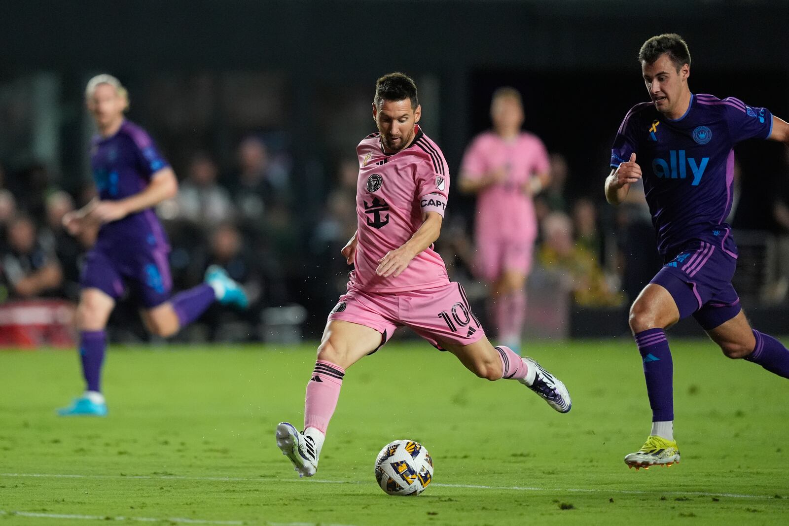 Inter Miami forward Lionel Messi (10) takes a shot, pursued by Charlotte FC midfielder Andrew Privett (34) during the first half of an MLS soccer match, Saturday, Sept. 28, 2024, in Fort Lauderdale, Fla. (AP Photo/Rebecca Blackwell)