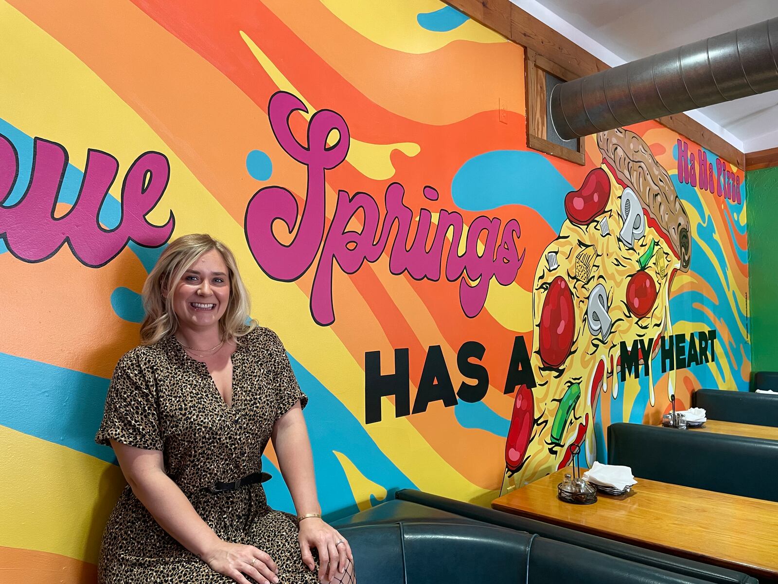 Dayton-area artist Chloé Chicarelli has put her love for Yellow Springs and Ha Ha Pizza on display through a new mural inside the pizza shop. NATALIE JONES/STAFF