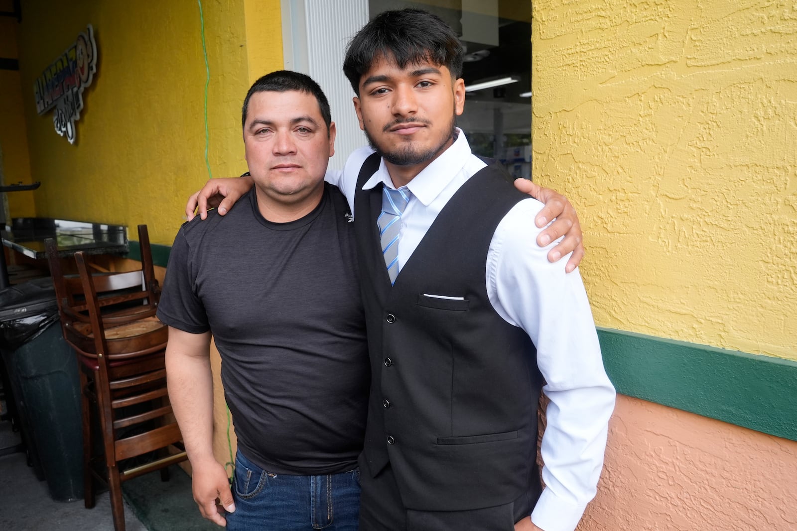 FILE - Billy and his father, no last name given, pause after speaking at a Democratic Party campaign event about their experience of being separated at the U.S.- Mexico border during the Trump administration, Oct. 16, 2024, in Doral, Fla. (AP Photo/Marta Lavandier, File)