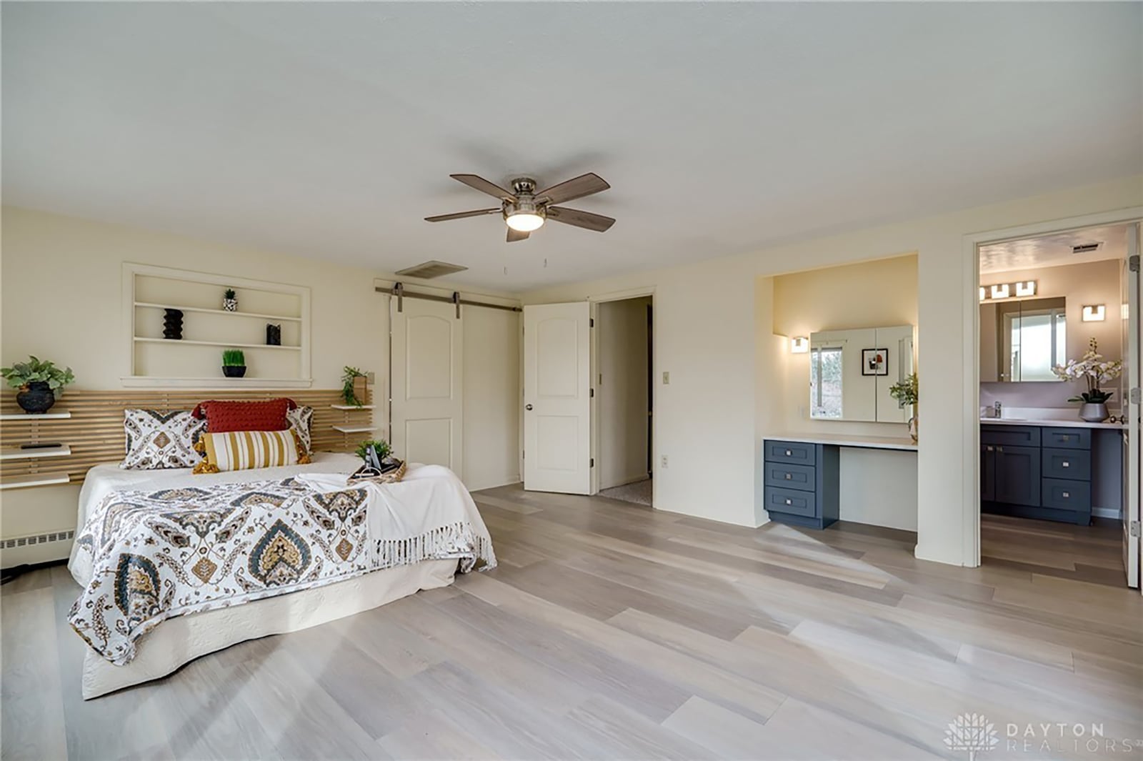 The primary bedroom suite has new flooring, a ceiling, remodeled onsuite bathroom and an oversized walk in closet with built in shelving.