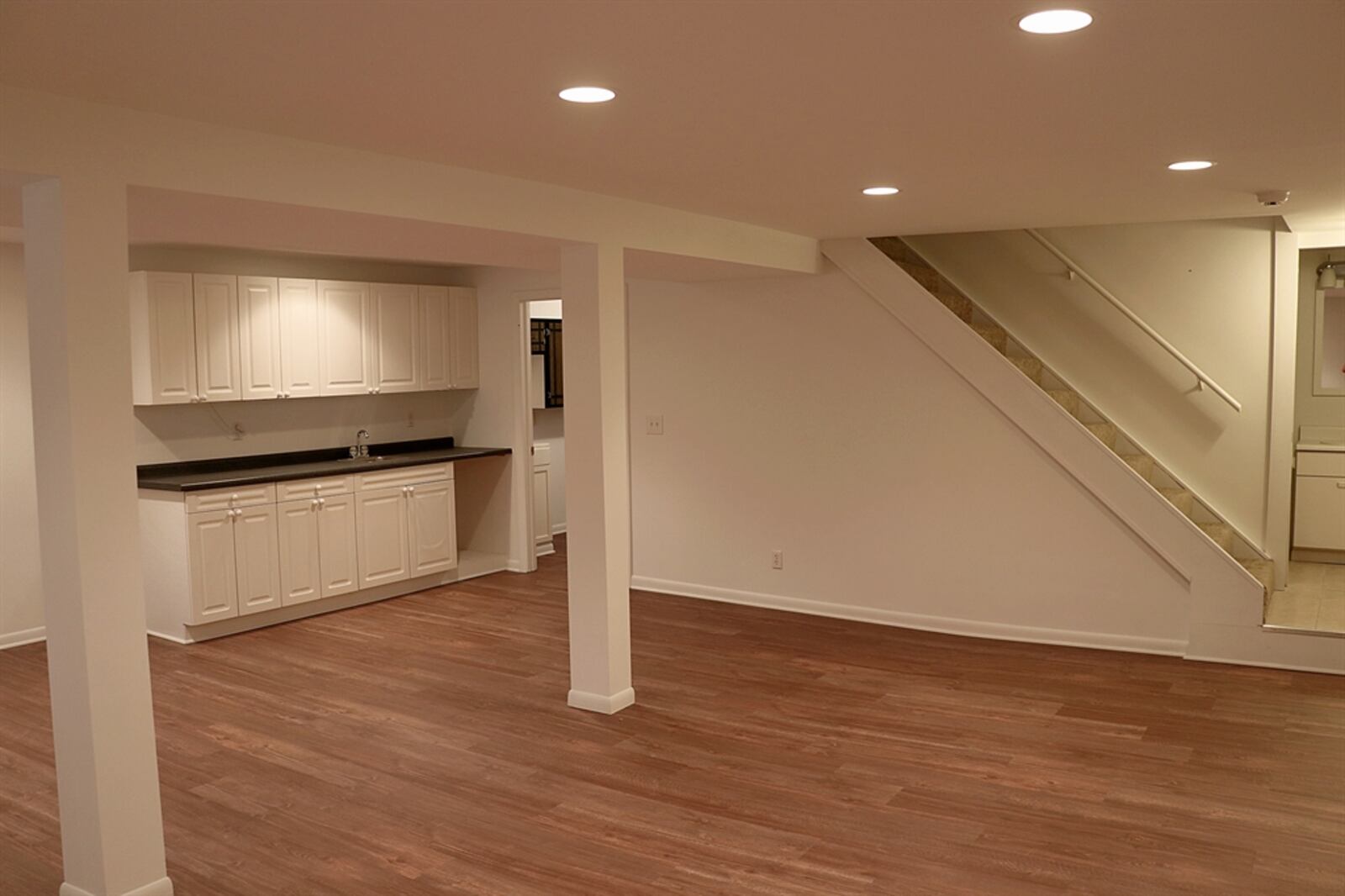 In the recreation room, a wet bar area offers plenty of counter space and cabinetry.