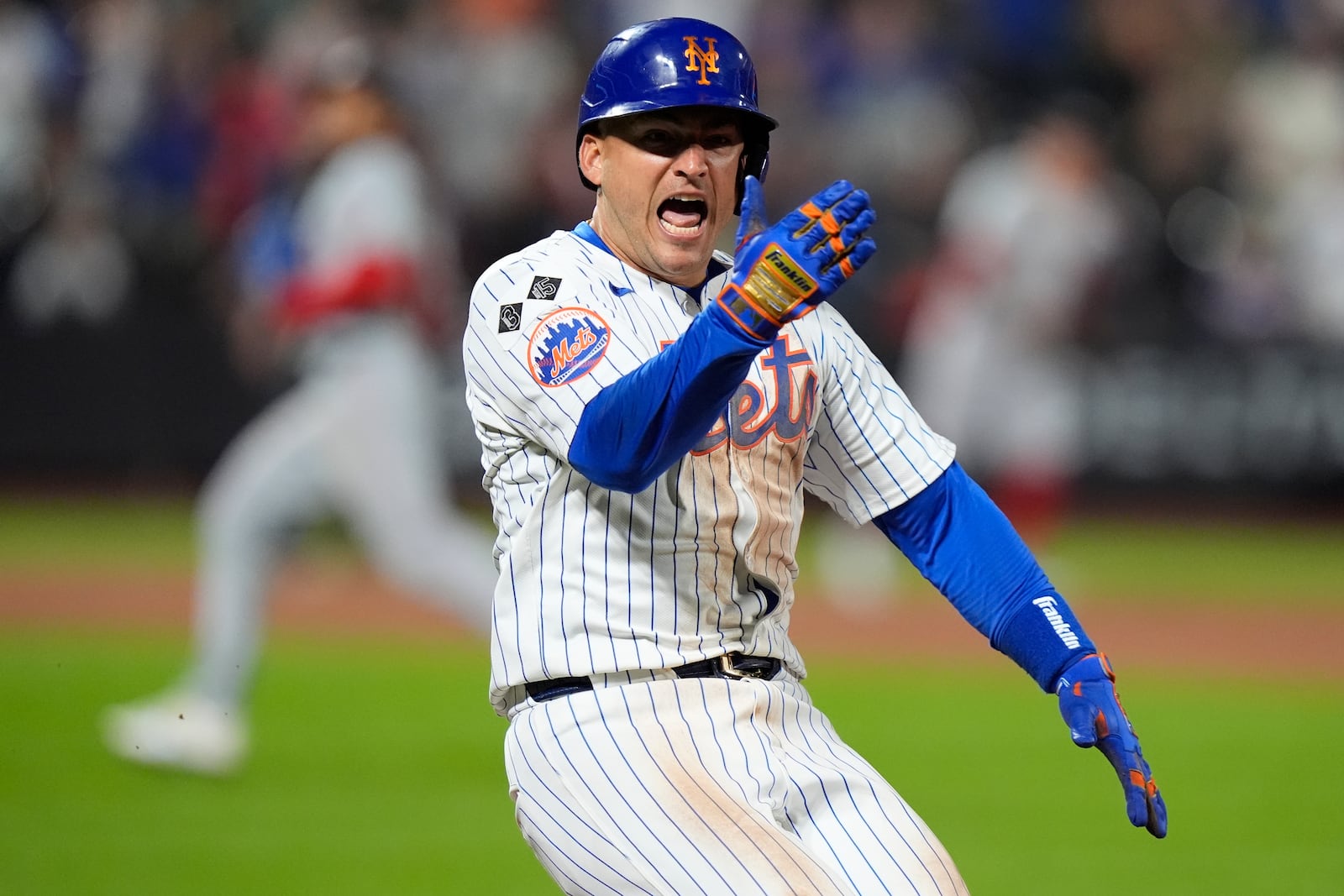 New York Mets' Jose Iglesias celebrates after hitting an RBI single during the eighth inning of a baseball game against the Washington Nationals, Monday, Sept. 16, 2024, in New York. (AP Photo/Frank Franklin II)